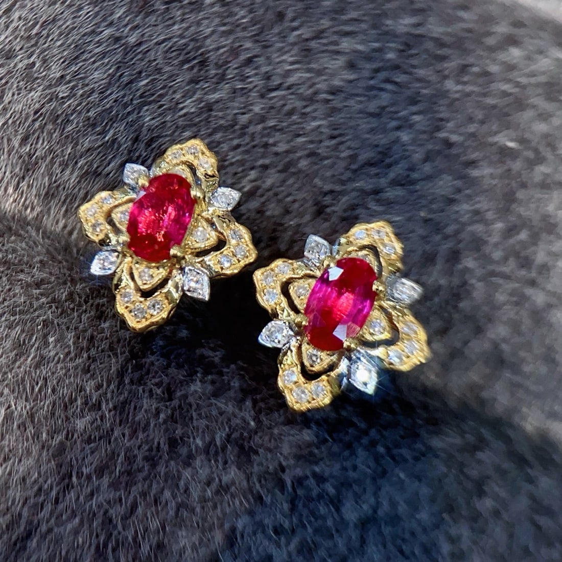 18K Gold Ruby Earrings: Title: 18K Gold Ruby Earrings Description: These earrings feature a natural ruby as the focal point, accented by brilliant small diamonds. The gold floral base outlines the luxurious silhouette of Eur