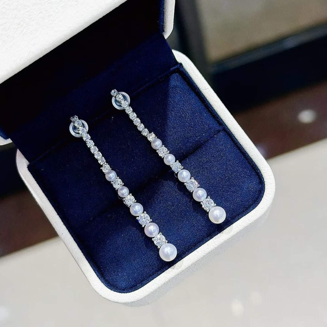 Freshwater Pearl Threader Earrings: Title: Freshwater Pearl Threader Earrings Description: These threader Earrings feature natural freshwater pearls with an aurora-like cool white luster. Pearl diameter is 3-5mm, perfectly round with
