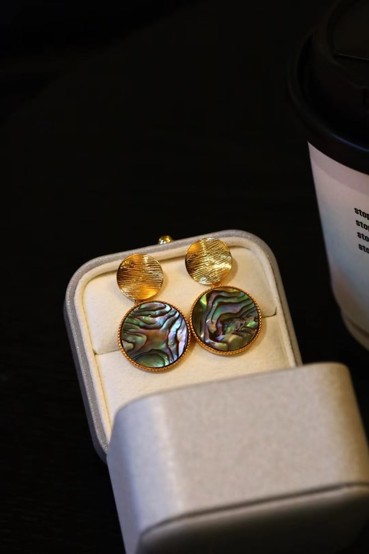 Sterling Silver Gold-Plated Natural Abalone Shell Earrings: Title: Sterling Silver Gold-Plated Natural Abalone Shell Earrings Description: These earrings are crafted from natural abalone shells, each with a unique pattern and iridescent luster. The exquisite