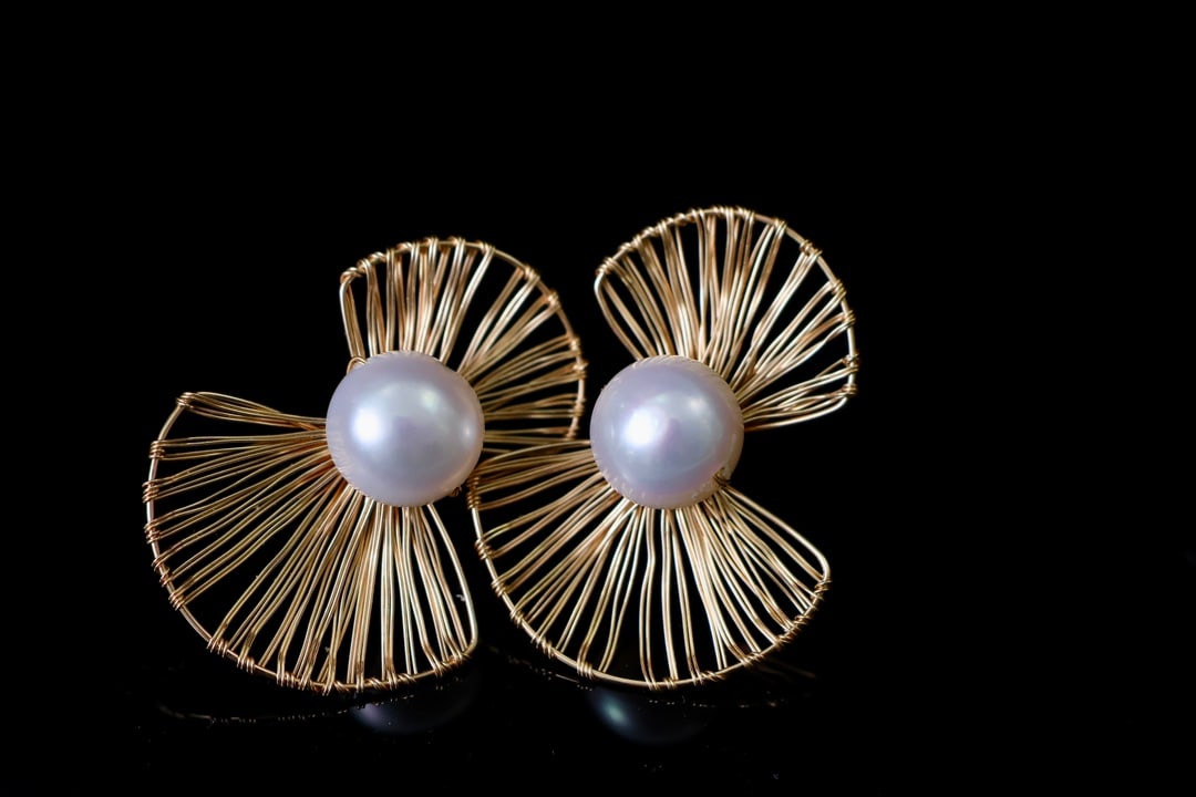 Natural Freshwater Pearl Earrings: Title: Natural Freshwater Pearl Earrings Description: These earrings feature material with natural freshwater pearls, measuring 10-11mm. The pearls exhibit a rich golden hue with strong luster, minima