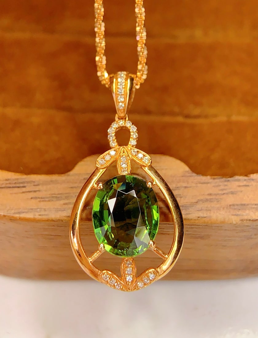 18K Gold Natural Tourmaline Pendant: Title: 18K Gold Natural Tourmaline Pendant Description: This pendant features a natural tourmaline as the main stone, showcasing a rich golden luster and cool white hue. The large diameter tourmaline