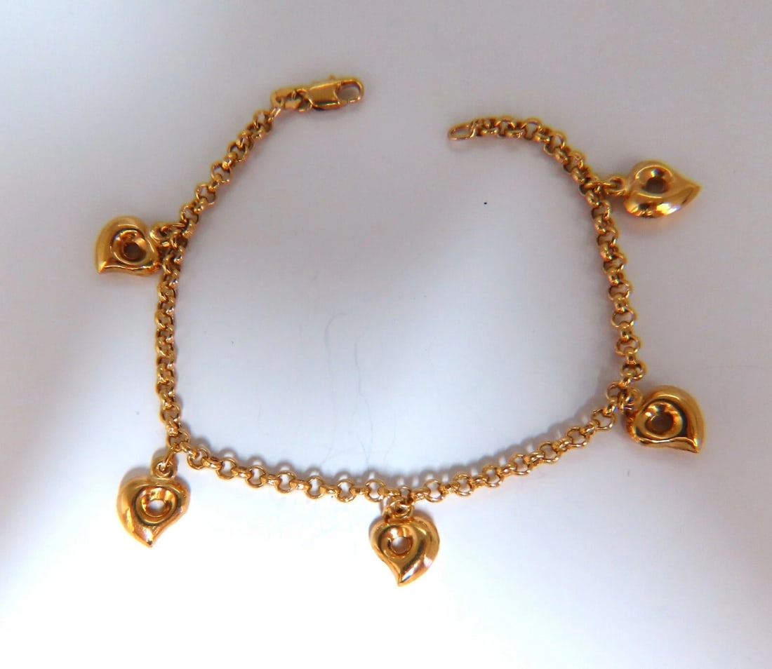 Five heart charm link bracelet 14 karat gold 7 inch**: Title: Five heart charm link bracelet 14 karat gold 7 inch** Description: Five heart charm link bracelet. Each charm 9x8 mm Chain 3mm caliber 14 karat yellow gold 4.9 g Bracelet measure 7-in Secure lo