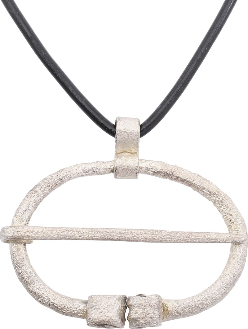 ANCIENT VIKING PROTECTIVE BROOCH 850-1050 AD: Just under 1 5/8" width, oval form with the ends deeply reeded and curled. Original cross pin. Worn in numbers on the leather war jerkin, at an ounce each, a few pounds could be added providing