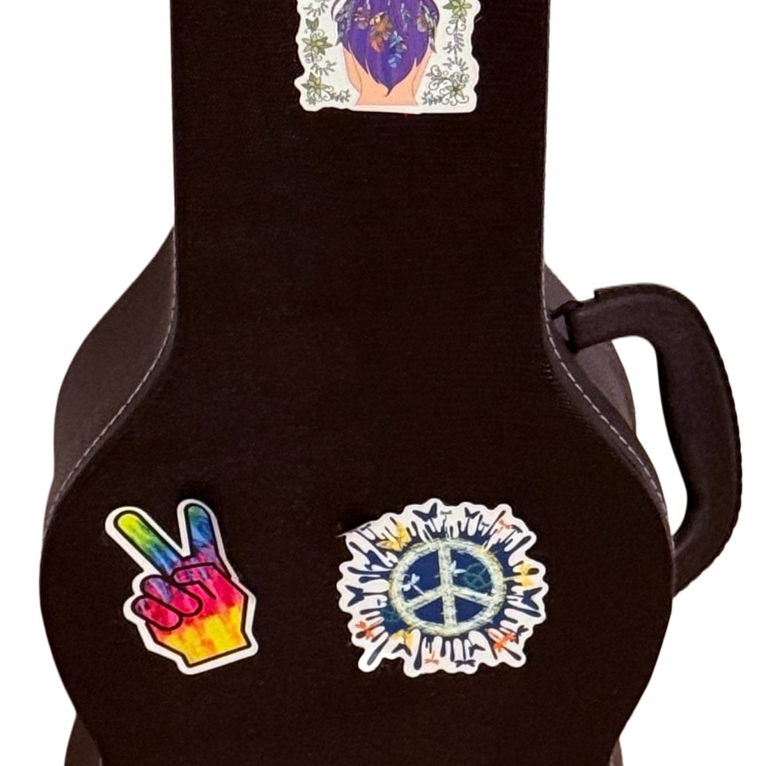 Guitar Shaped Storage Case: A dark brown, contoured case, likely for a ukulele or similar small stringed instrument, adorned with a collection of peace, folk art, and counter-culture themed stickers. The case has a textured