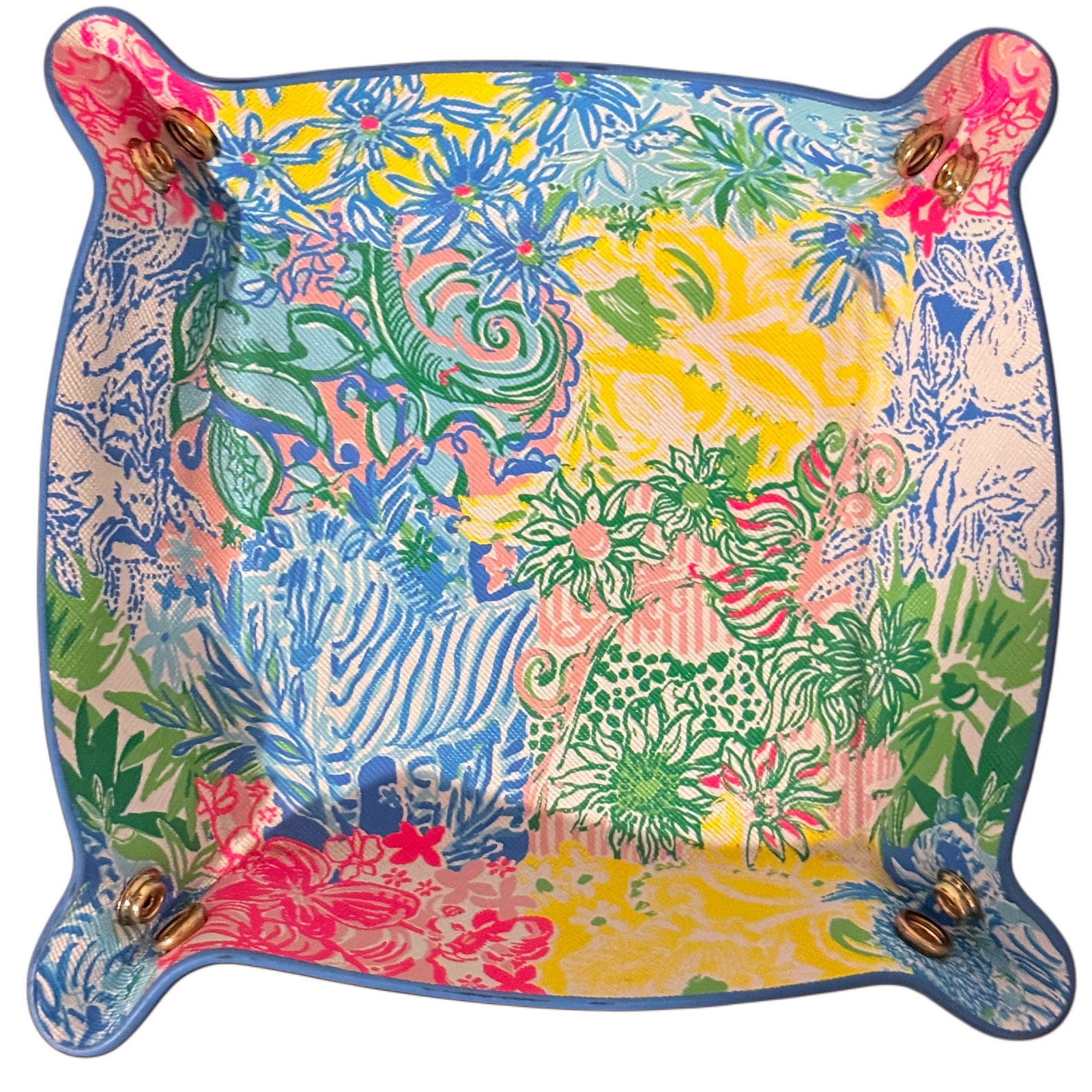 Lilly Pulitzer Printed Valet Tray: A vibrant valet tray, likely crafted from faux leather or coated canvas with a textile interior, featuring a colorful and intricate patchwork floral and botanical print characteristic of Lilly
