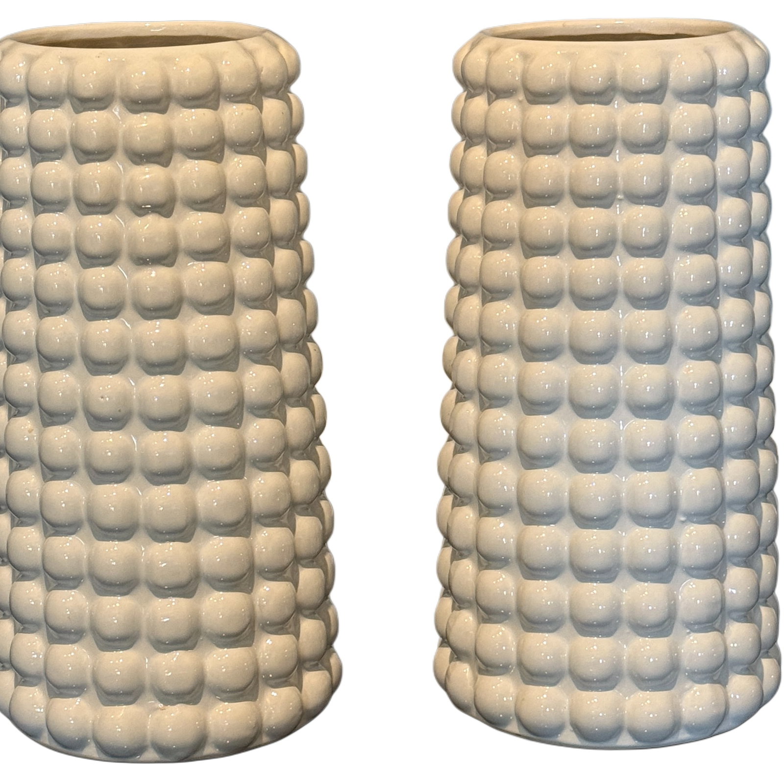 Pair of Modern White Ceramic Corn-Cob Vases: A contemporary pair of white ceramic vases, each featuring a textured, raised "corn-cob" or "popcorn" motif. The vases are cylindrical with a slightly flared rim. The glaze is a glossy white, highligh