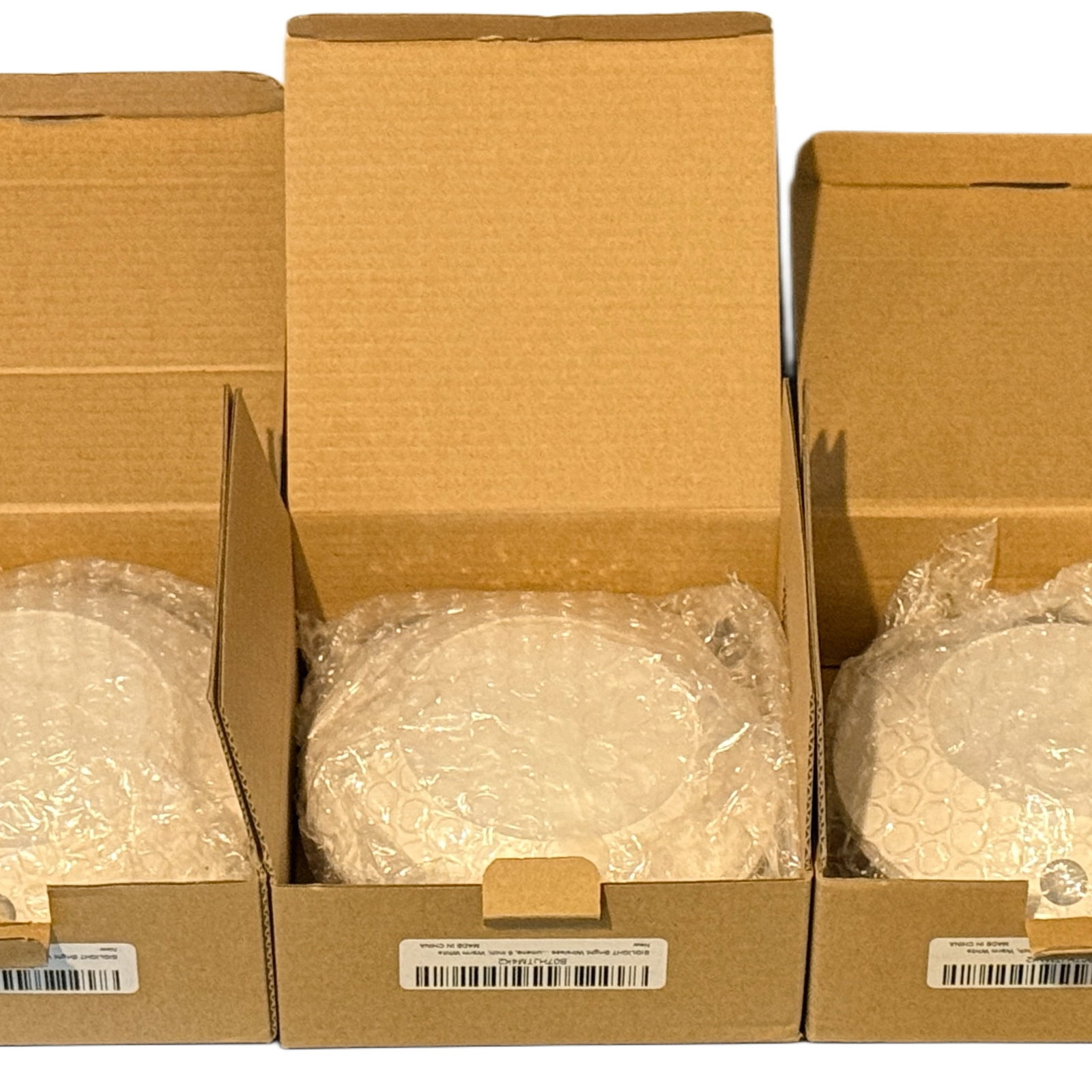Wireless LED Motion Sensor Ceiling Lights, Set of 3: A set of three wireless LED ceiling lights with built-in motion sensors. Each light is housed in a minimalist white plastic dome, designed for easy installation with included hardware (screws and