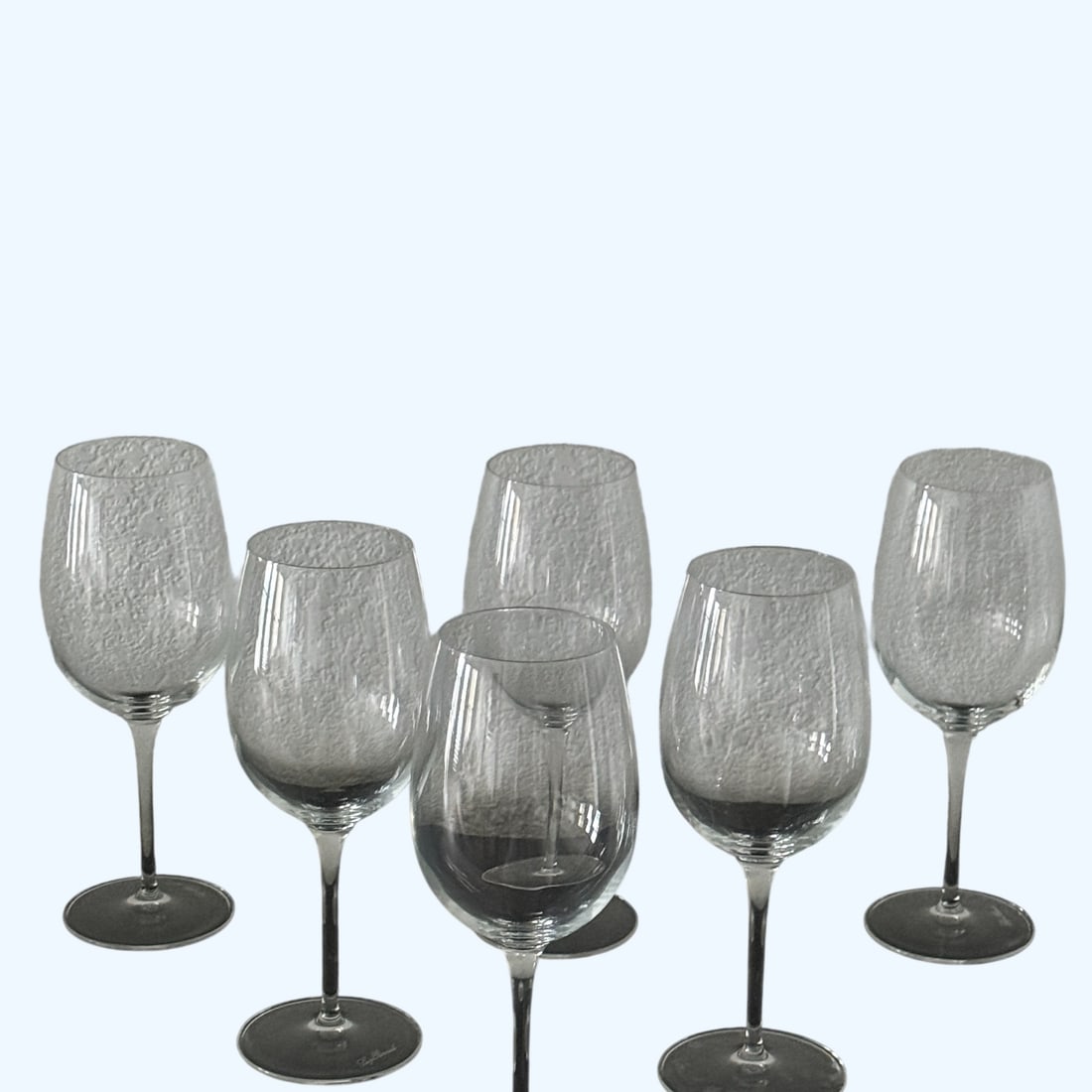 Set of Six Contemporary Clear Stemmed Wine Glasses: A set of six contemporary clear stemmed wine glasses, likely dating from the late 20th or early 21st century. Each glass features a classic bowl shape, a slender stem, and a stable circular foot.