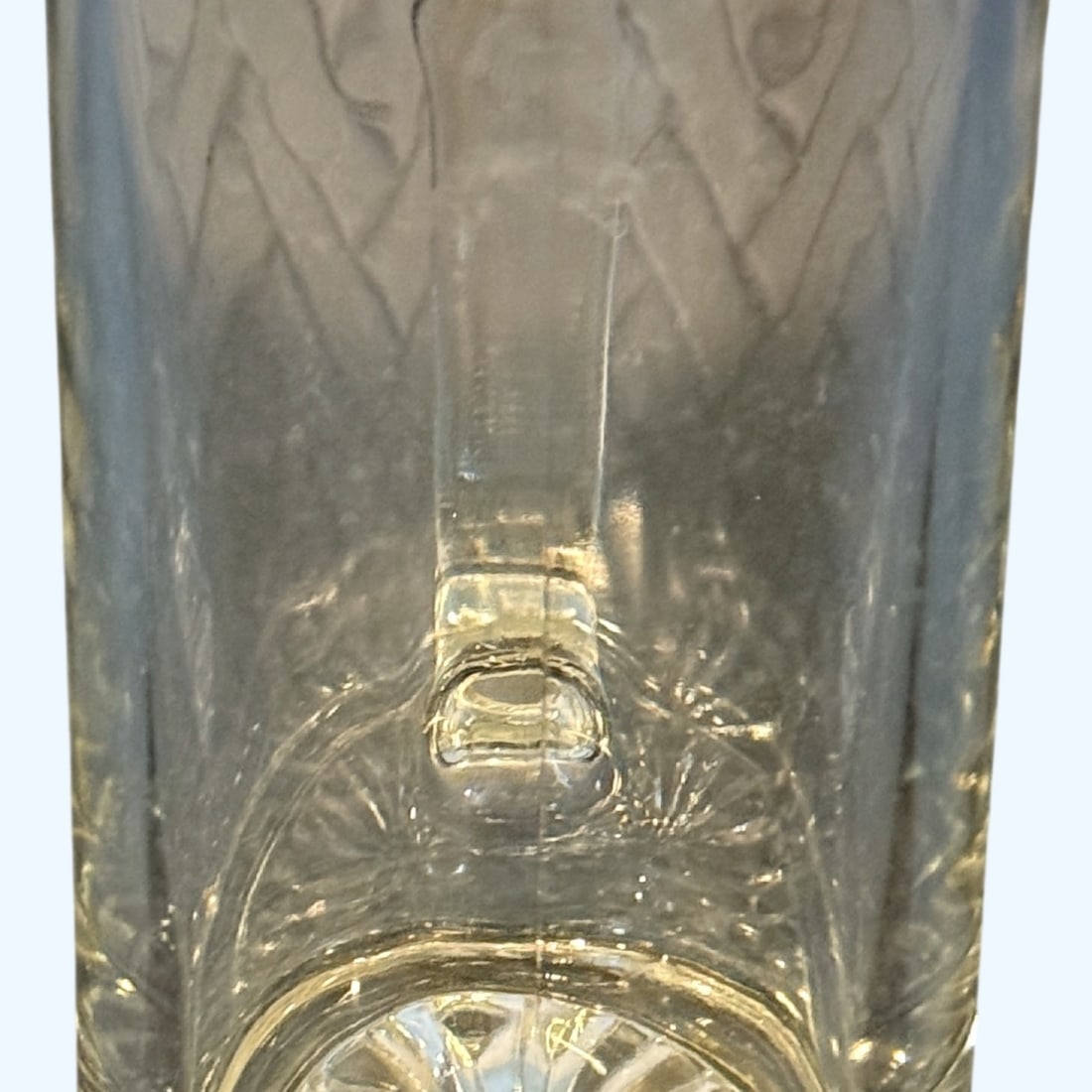 Clear Glass Beer Mug: A clear glass beer mug, likely from the mid to late 20th century. The mug features a sturdy handle and a decorative starburst pattern on the base, providing a touch of classic tavern style.