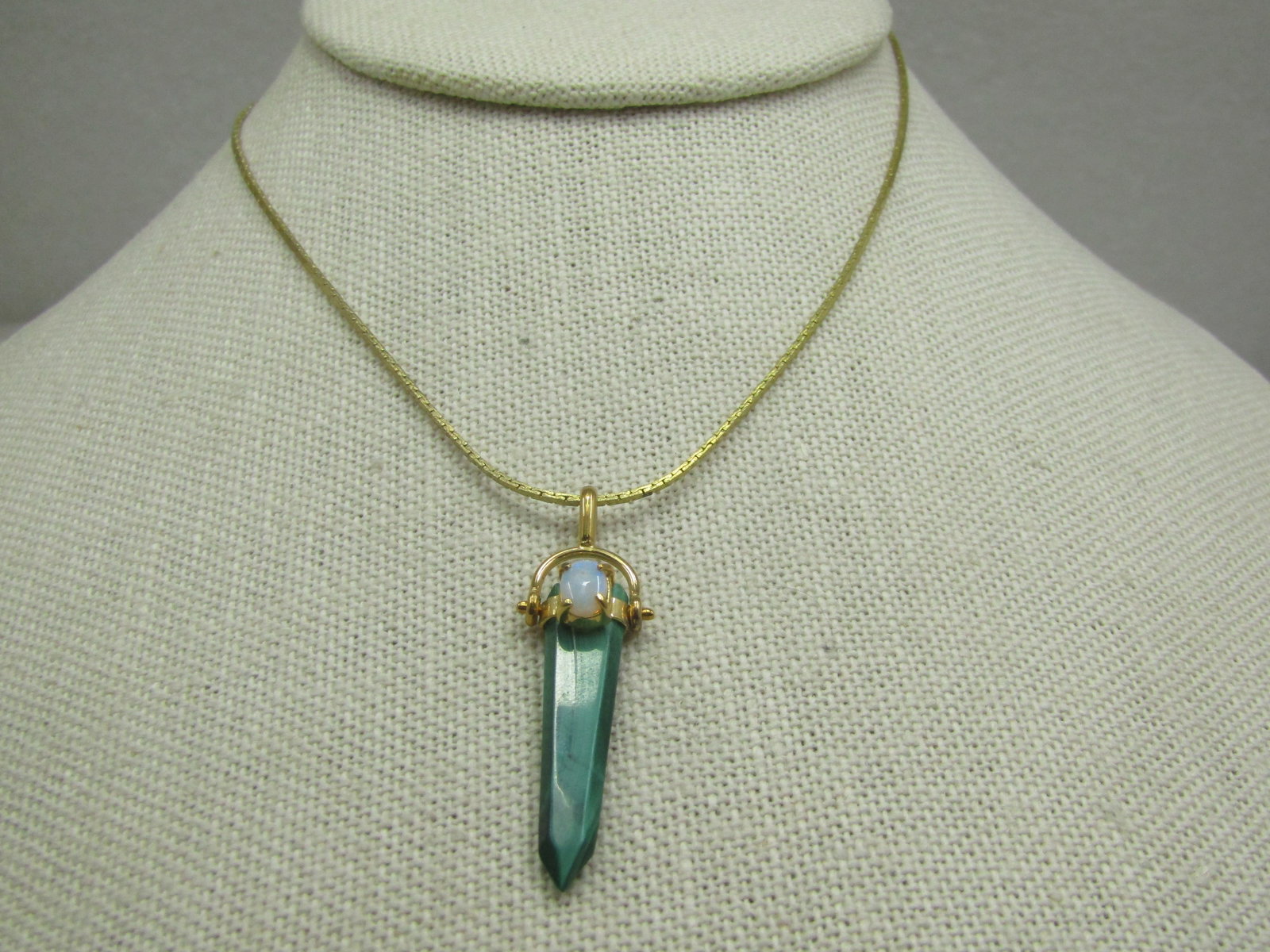 Vintage Malachite Faux Opal Crystal Pendant on 19" 1mm square chain with spring clasp: Vintage Malachite Faux Opal Crystal Pendant on 19" 1mm square chain with spring clasp. Gold Tone. The pendant is appx. 1-5/8" long and 1/2" wide. The faux opal is oval and appx. 5mm by 3.5mm. Very