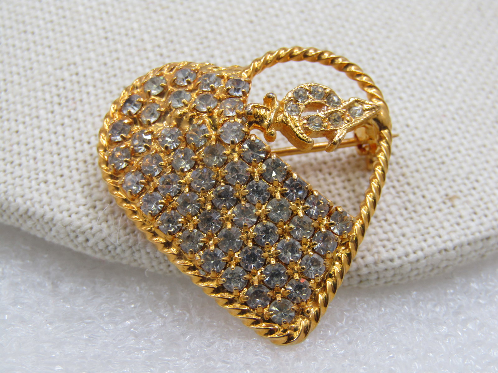 Vintage Rhinestone Shriner's Saber Heart Brooch, 1.25": Vintage Rhinestone Shriner's Saber Heart Brooch, 1.25" by 1.25". Gold tone. Boumi Shrine Temple Symbol. Over half of the brooch are clear rhinestones in rows with a rope accent heart frame. The upper
