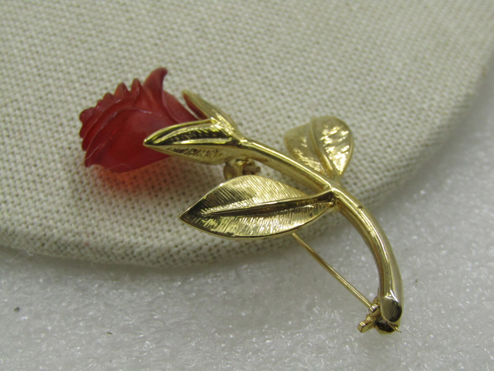 Vintage Red Amber Pressed Rose Brooch, 2", 1960's: Vintage Red Amber Pressed Rose Brooch, 2" tall and 1.25" wide. 1960's. Gold tone textured leaves with smooth curved stem. Not signed or marked. Very good condition. The rose is a pressed reddish