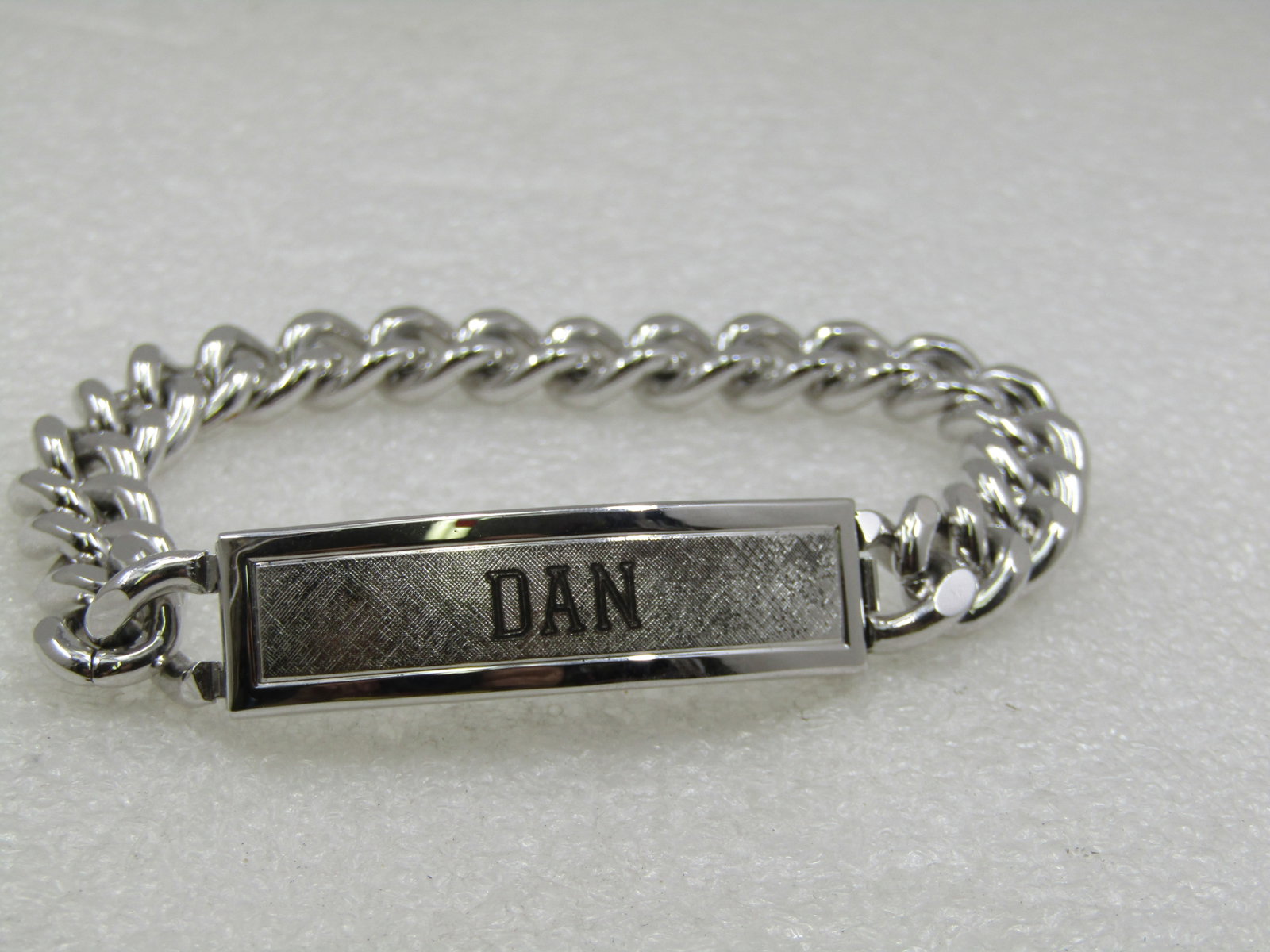 Sterling & Stainless Steel Engraved DAN Men's I.D. Bracelet, 8.25": Sterling & Stainless Steel Engraved DAN Men's I.D. Bracelet, 8.25" long and 11mm wide stainless heavy curb link chain with an 11mm curved stainless stell and brshed stering top to the bracelet where
