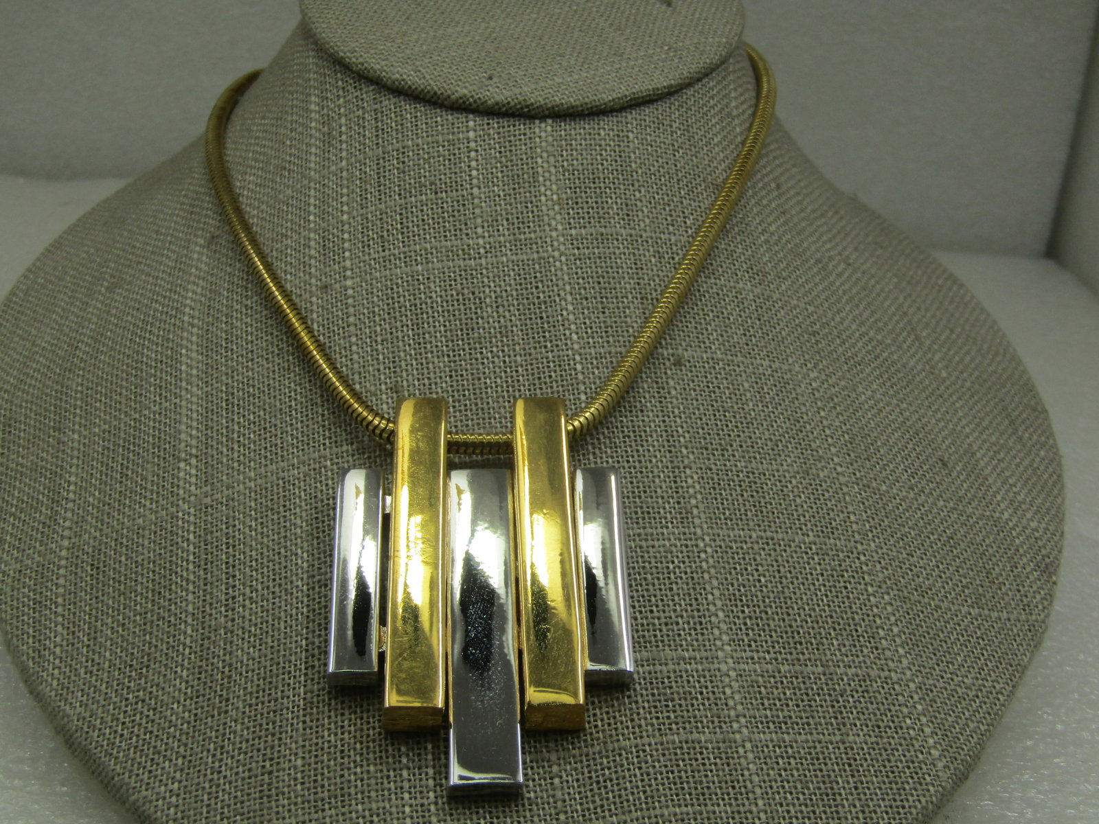 Vintage Two Tone Mod Staggered Bar Necklace, 20" Snake Chain, Avon: Vintage Two Tone Mod Staggered Bar Necklace, 20" Snake Chain, Avon. The pendant has two gold tone bars and three silver tone bars, 2.5" by 1.5". The chain is appx. 3mm wide with spring clasp. Signed