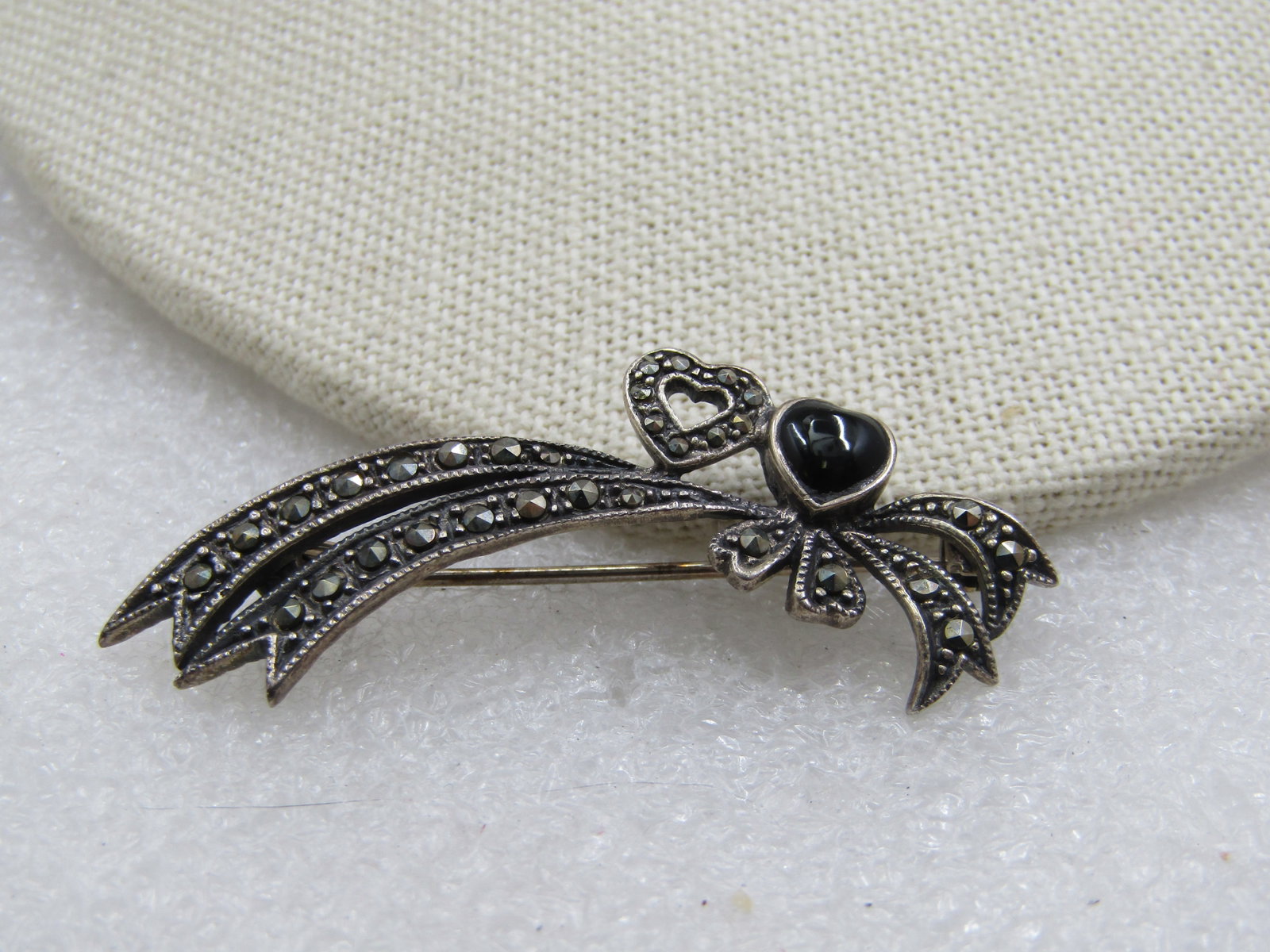 Vintage Sterling Double Heart Marcasite Brooch, 2": Vintage Sterling Double Heart Marcasite Brooch, 2" appx 1980's. Signed with an unknown mark. This has an outlined heart and an onyx heart that are appx 1/3" tonearly 1/2" tall and wide. SWith a double