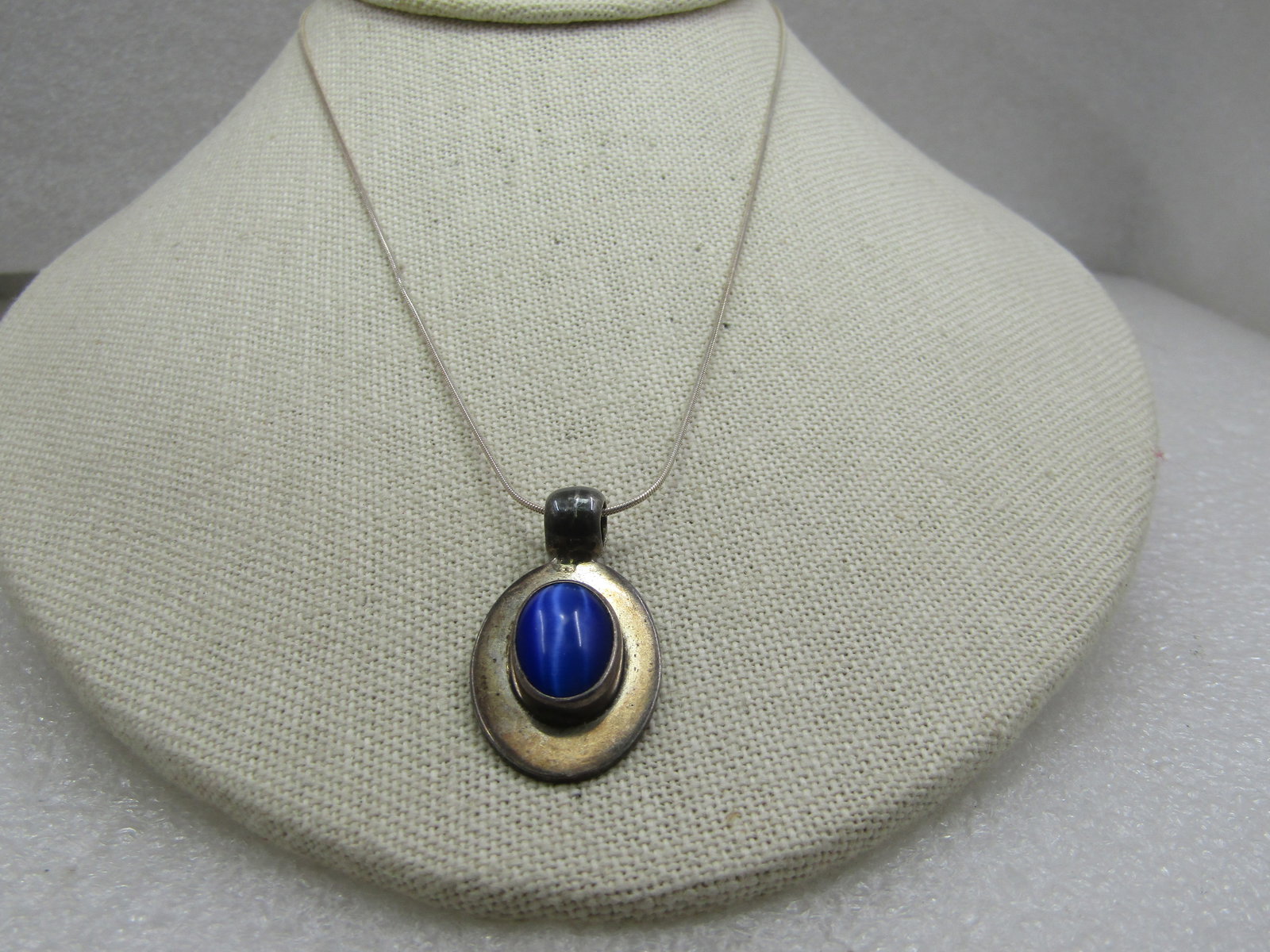 Vintage Sterling Mexico Blue Cateye Cabochon Necklace, 16": Vintage Sterling Mexico Blue Cateye Necklace, 16", Southwestern/Mexican with a 14mm by 10mm oval cabochon set with a t all bezel and sits on an 1.25" by 3/4" sterling base (incuding the bail that is
