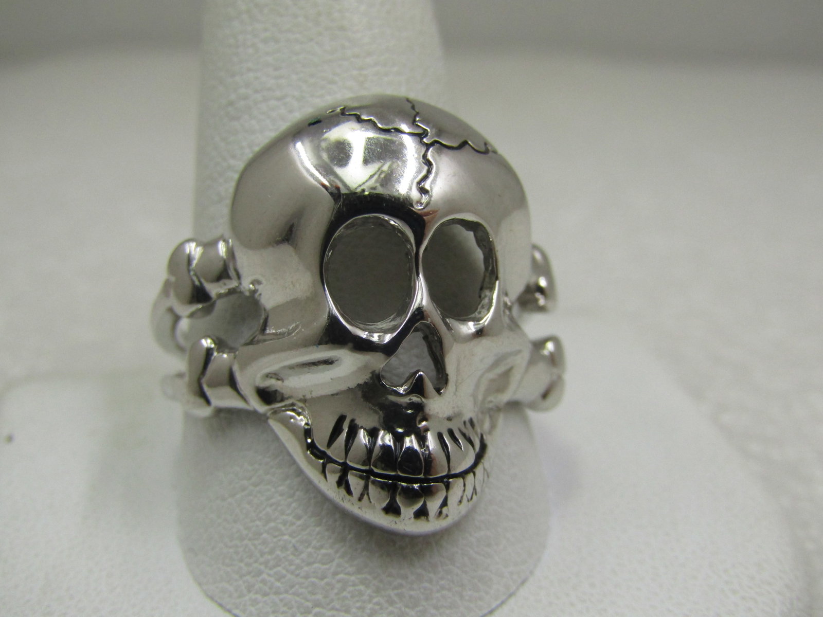 Men's Skull Biker Ring, Sz. 12.5, Silver Tone: Men's Skull Biker Ring, Sz. 12.5, Silver Tone. The ring is appx. 1" down and across the top of the finger with a skull and two bones coming out from the sides creating a double band at top shoulds