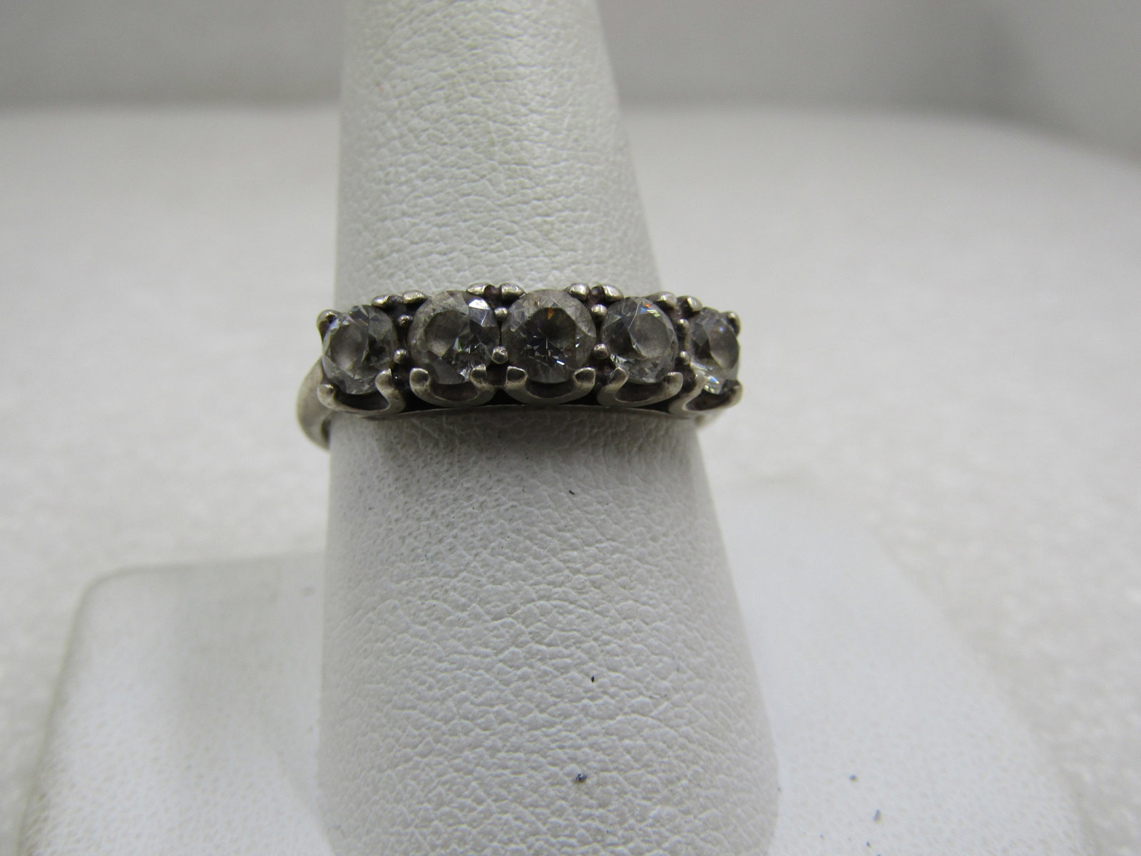 Vintage Sterling CZ Wedding/Anniversary Band, 1 TCW, Size 10: Vintage Sterling CZ Wedding/Anniversary Band, Size 10. 1 TCW in CZ. It is marked sterling and tested. Weight is appx. 3.39 gr. It has five round cut stones that are appx. 4mm wide set in a have