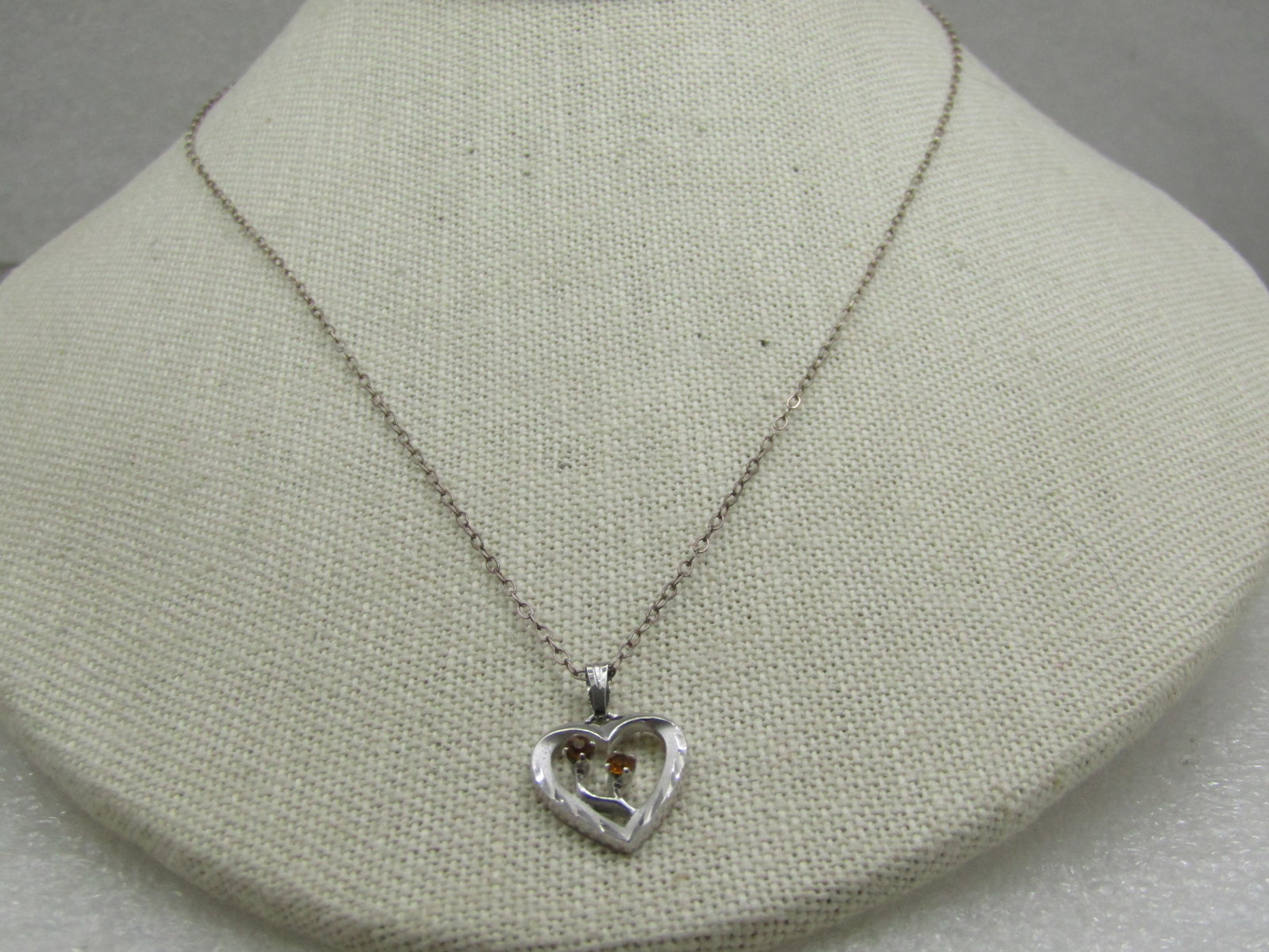 Vintage Sterling Citrine Heart Necklace, Birthstone, 18": Vintage Sterling Citrine Heart Necklace, Birthstone, 18". The pendant is a sterling open heart with diamond-cut accents and satin and smooth finish with two stems with a citrine stone in each that is