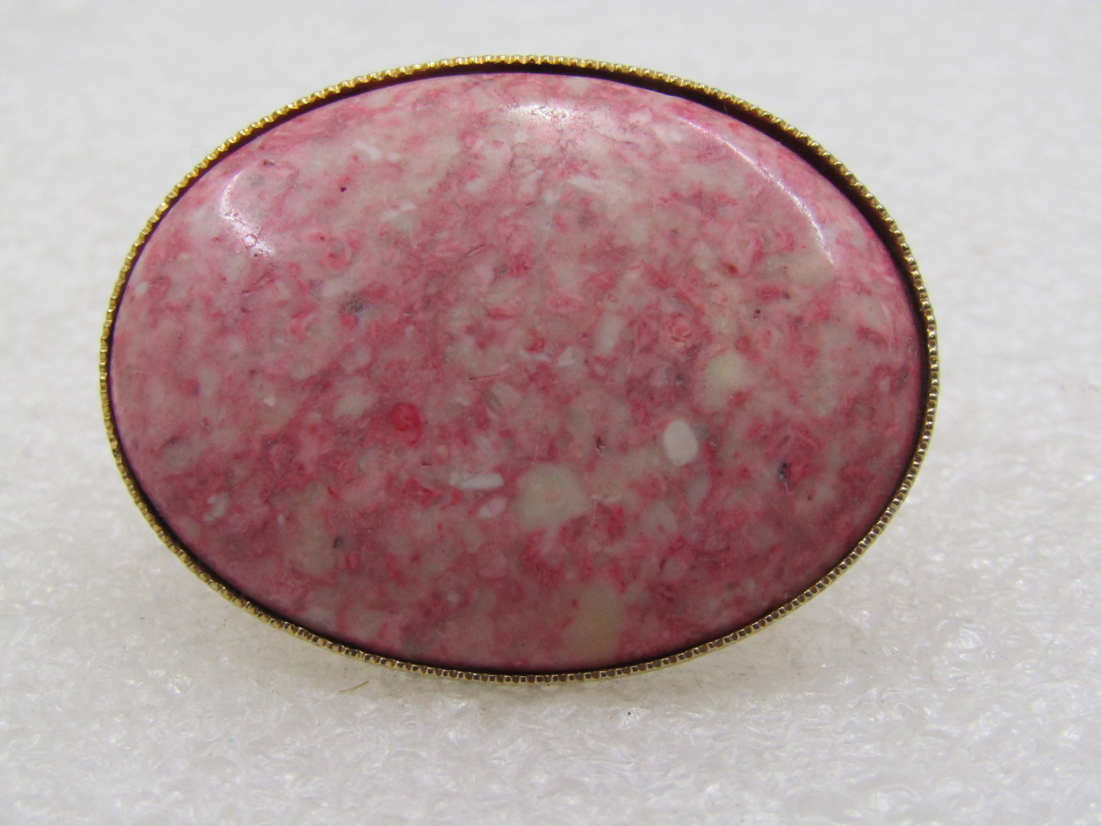 Vintage Pink Agate Scarf Clip, 1970's, Southwestern Themed: Vintage Pink Agate Scarf Clip, 1970's Large 1.5" by 1.25 oval pink agate bezel-set stone on top with gold tone setting and a locking hinged locking clasp on the back of the clasp. It is not signed by