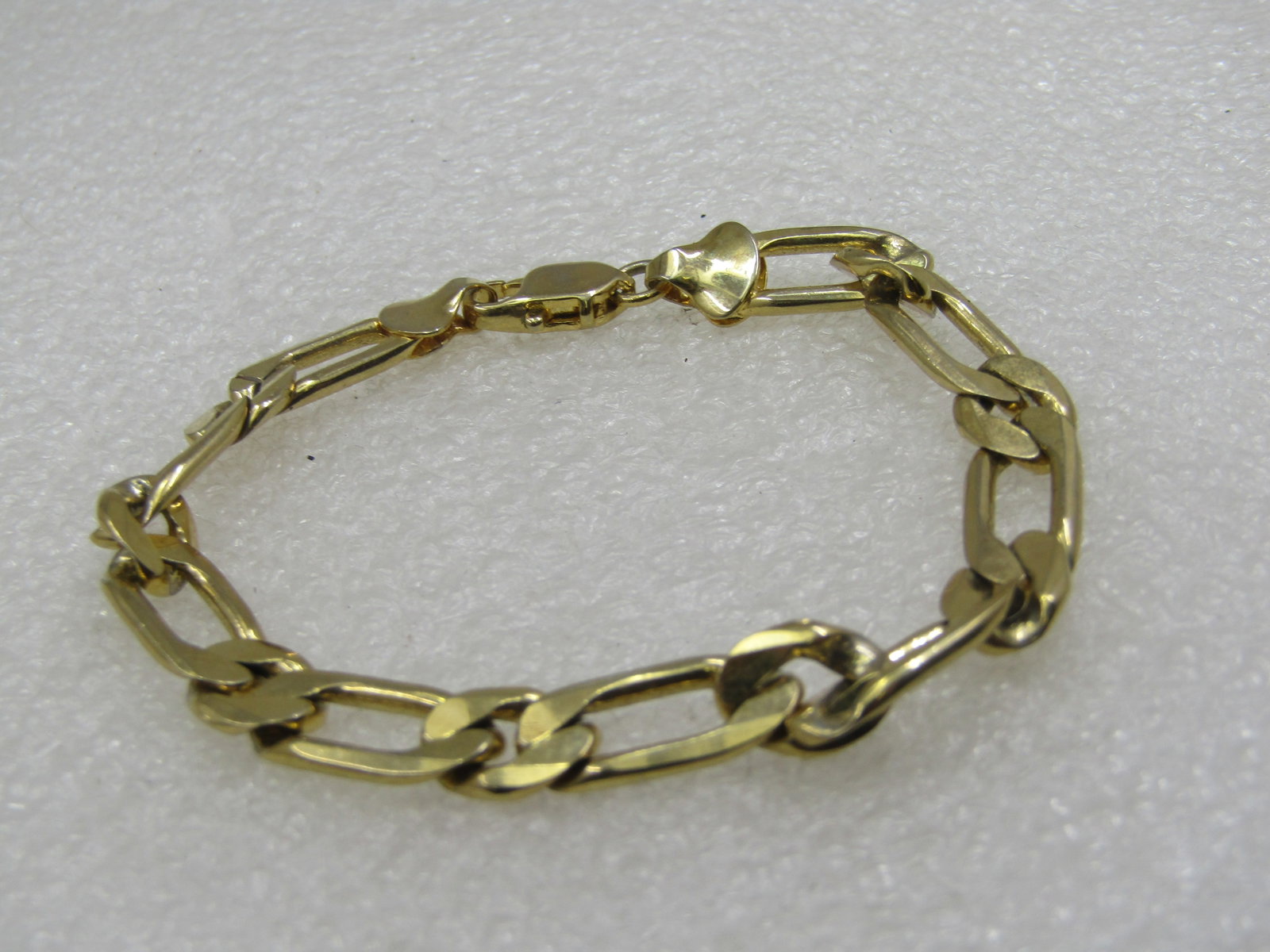 Vintage Gold Plated Figaro 7.5mm Wide Bracelet, 7.25": Vintage Gold Plated Figaro 7.5mm Wide Bracelet, 7.25". Lobster clasp. Not signed by the maker. Unisex bracelet. Finish is intact and looks like it was not worn. Age is estimated at 1980's-1990's.