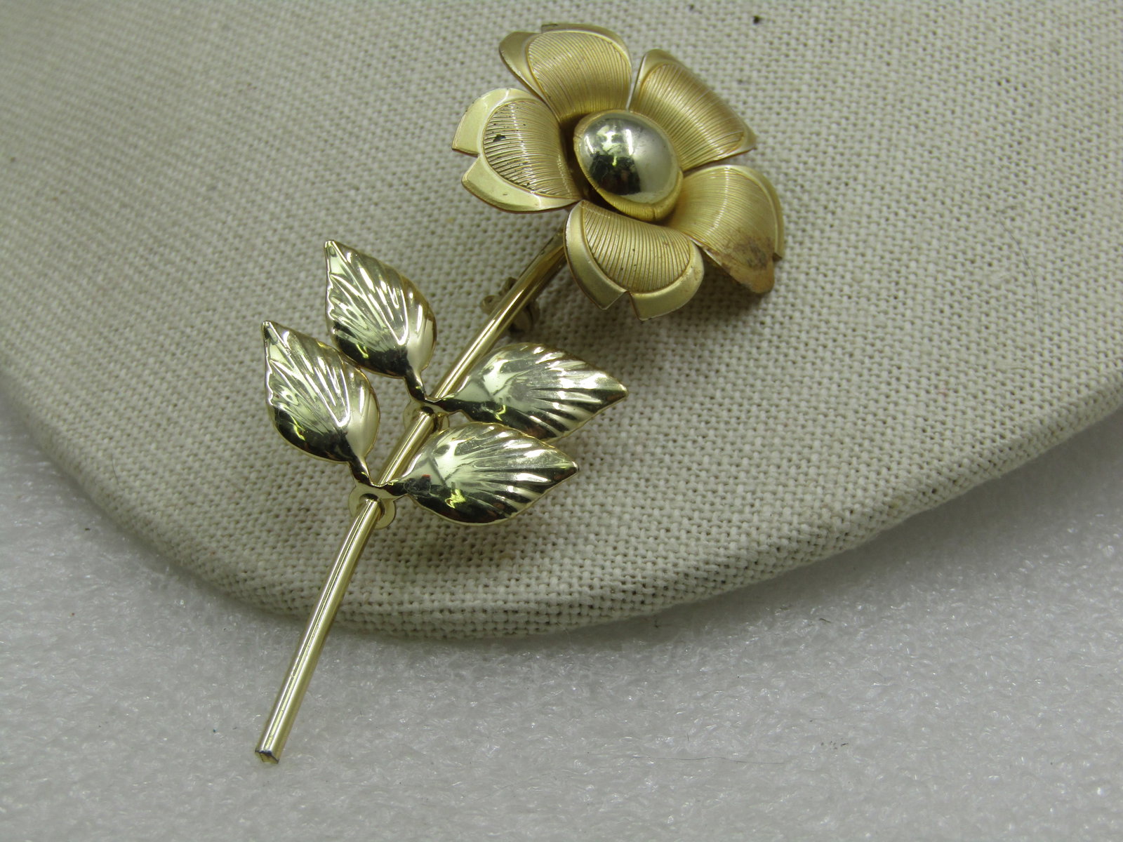 Vintage Long Stem Floral Brooch, 1960's-1970's, 3.5": Vintage Long Stem Floral Brooch, 1960's-1970's, 3.5" long and 1.25" wide. Gold tone, satin and shiny finish with a five petal curved blossom and shiny domed center and four shiny leaves. It is not sig