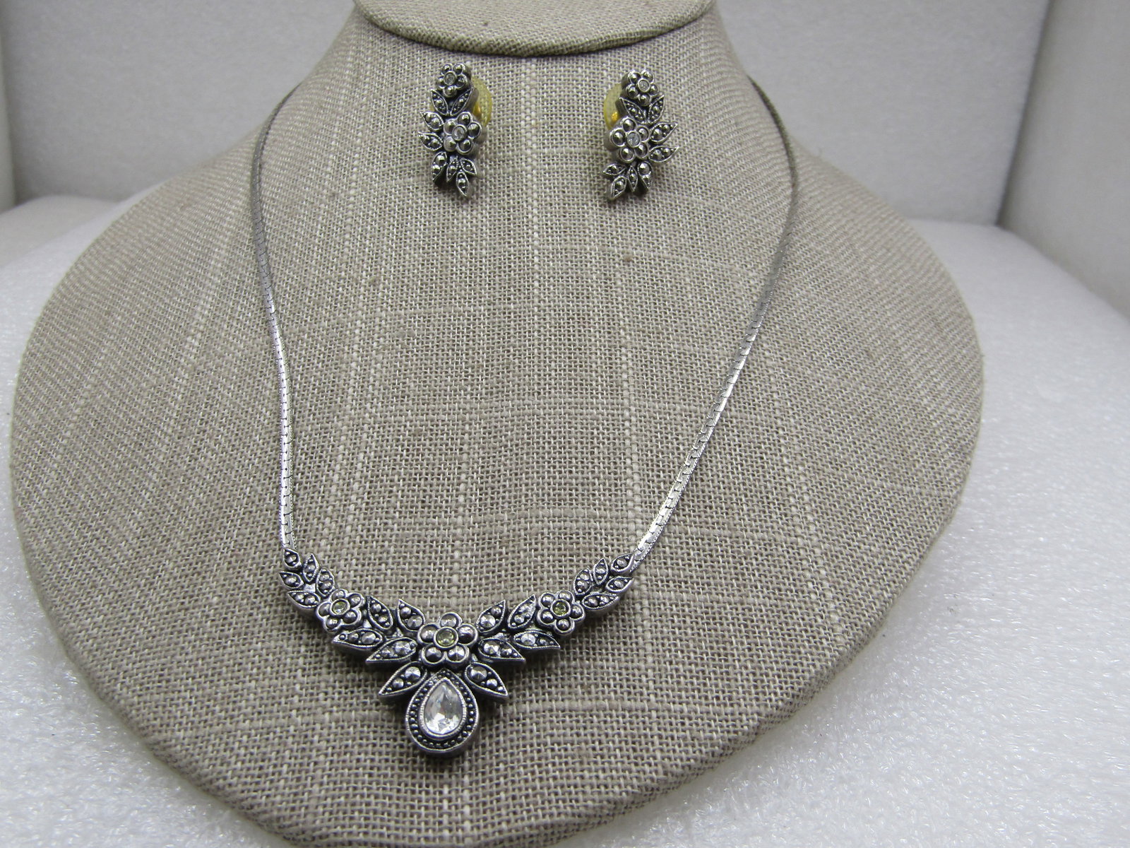 Vintage Faux Marcasite & CZ Necklace & Earrings Set, 18": Vintage Faux Marcasite & CZ Necklace & Earrings Set, 18". Slight bib at the front of the necklace with floral design and faux marcasite accents throughout. Pear-shaped rhinestone/CZ set at the center 