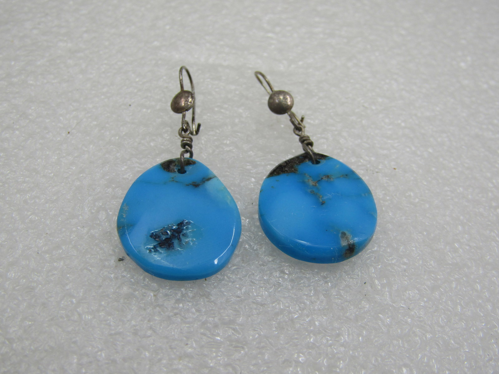 Vintage Sterling SouthWestern Turquoise Drop Earrings, 1970's-1980's: Vintage Sterling Southestern Turquoise Drop Earrings, 1970's-1980's. Sterling hook posts with a 4.5mm round accent on the front of the hook post and flat turquoise oval drops that are appx. 7/8" long