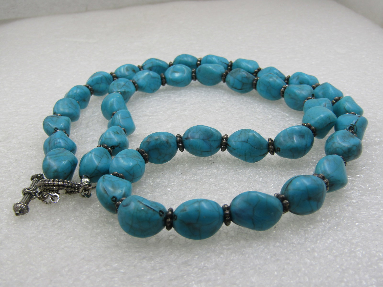 Vintage Southwestern Faux Turquoise Nugget Necklace, 24", 10mm, Toggle Clasp: Vintage Southwestern Faux Turquoise Nugget Necklace, 24", 10mm, Toggle Clasp with fluted silver p lated beads between each nugget. The nuggets have subtled black veining throughout. Simulated
