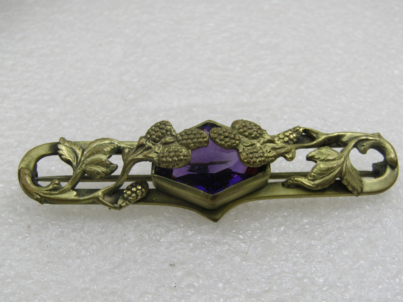Art Nouveau Amethyst Glass Thistle & Leaf Brooch, 3" wide: Art Nouveau Amethyst Glass Thistle & Leaf Brooch, 3" wide and 7/8" tall at center. Elaongated oval with a chunky pointed amethyst glass bezel-set stone that is appx. 22mm aby 17mm and sits up from