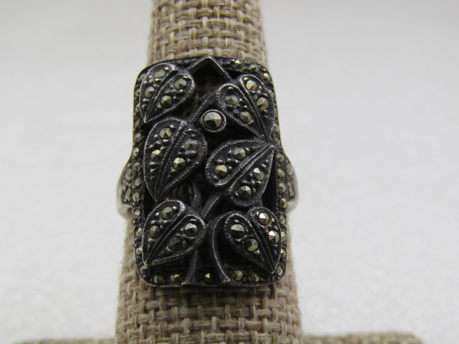 Vintage Sterling Marcasite Leaf Ring, Rectangular, Sz. 8: Vintage Sterling Marcasite Leaf Ring, Rectangular, Sz. 8. The ring is 1" down the finger and 3/4" across the ring in a cut-out design with six marcasite leaves curving over the finger. The upper shoul