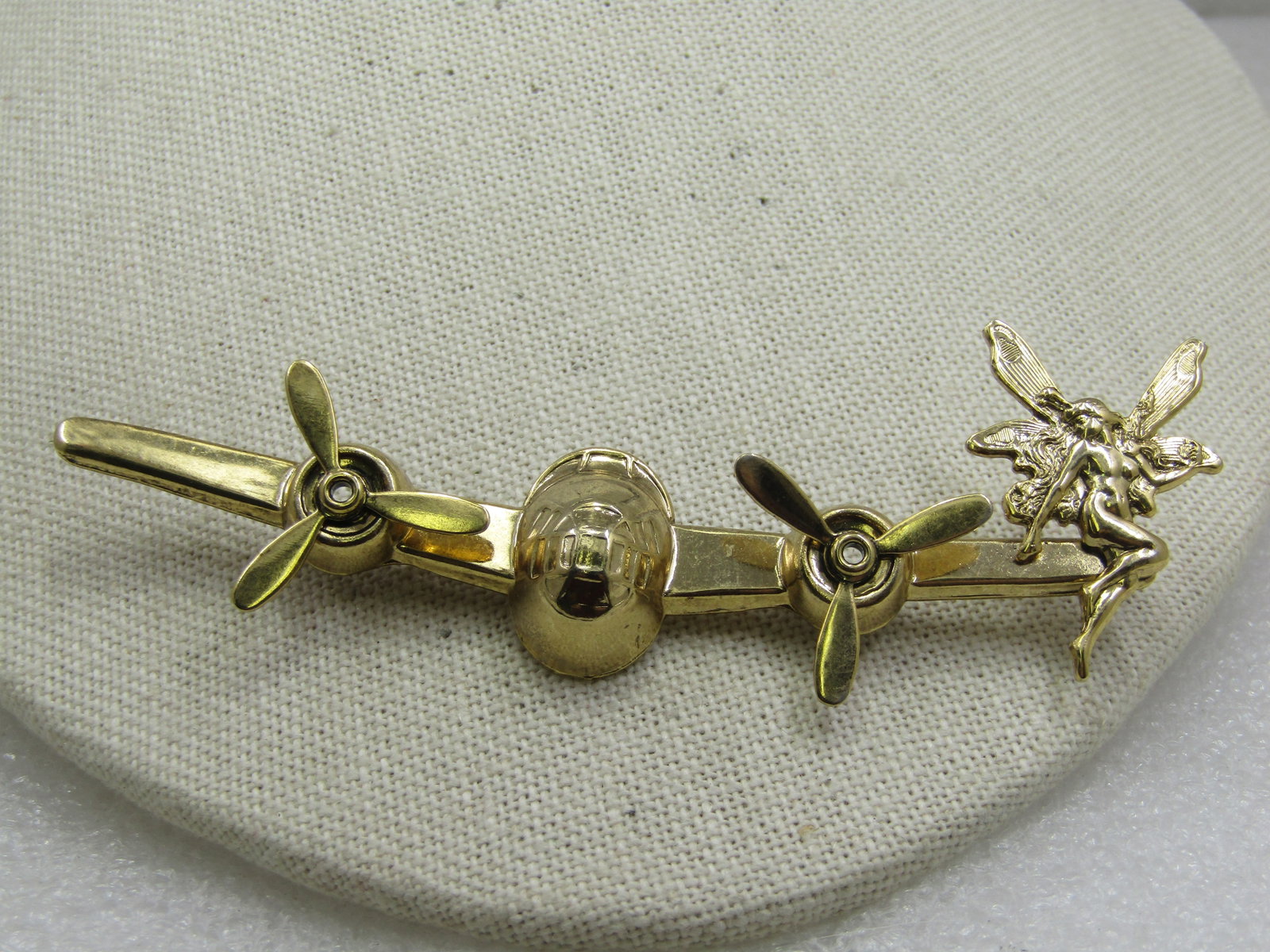 Vintage Brooch, Plane Front with Moving Engine parts and a Fairy on the Wing, 3-7/8": Vintage Brooch, Plane Front with Moving Engine parts and a Fairy on the Wing, 3-7/8" by 1" tall. This is viewing a plane from the front - the two front engines having spinning propellers and the
