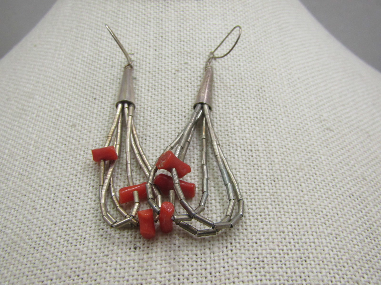 Vintage Sterling Southwestern Coral Drop Earrings, 2.75": Vintage Sterling Southwestern Coral Drop Earrings, 2.75". Locking hook sterling posts with triple strand of sterling liquid silver beaded hoops that each have a red coral nugget. Total length from