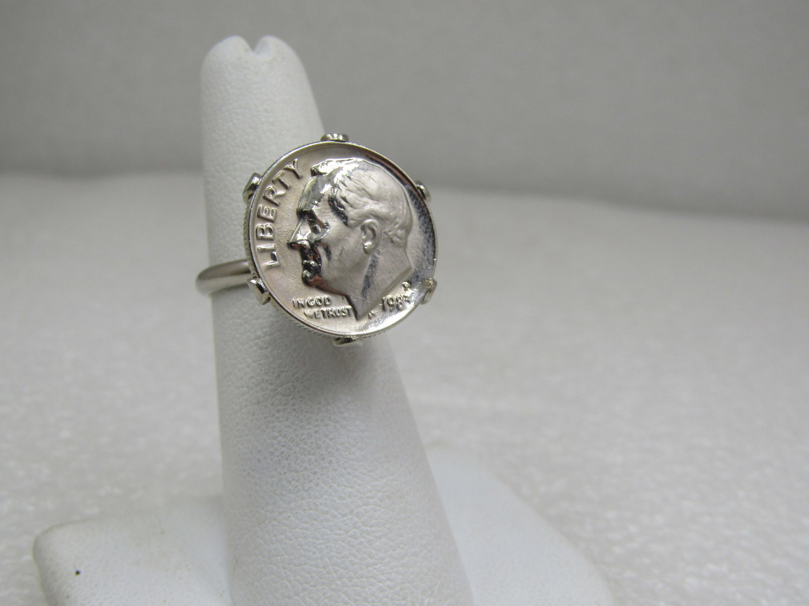 Vintage 1983 Dime Ring, Adjustable, Mod Design: Vintage 1983 Dime Ring, Adjustable, Mod Design. A 1983 P dime set in a high-sitting six-pronged setting. The band is adjustable Size 5-7. Silver tone metal and in very good condition. It does not