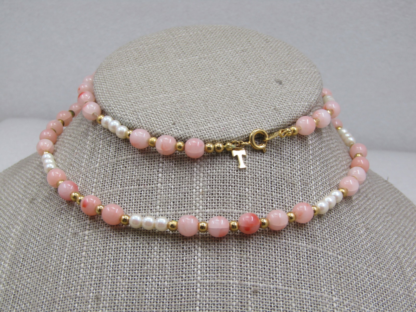 Vintage Trifari Faux Pink Coral & Pearl Necklace, 22", 1970's-1980's: Vintage Trifari Faux Pink Coral & Pearl Necklace, 22", 1970's-1980's. Beaded necklace with 5.5mm faux pink coral beads and 3mm faux pearls with gold tone spacer beads throughout. Gold tone. Spring