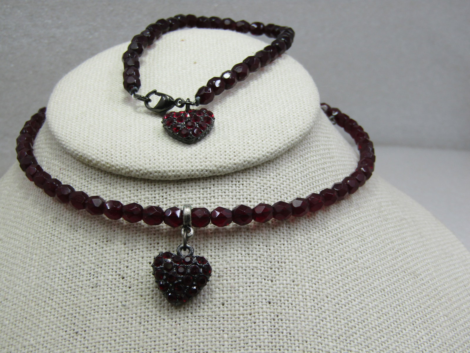 Vintage Red Faceted Beaded Necklace & Earrings Set: Vintage Red Faceted Beaded Necklace & Earrings Set. The beads are glass or crystal and faceted, the color of deep red garnets. The beads are appx. 4.5mm wide. The necklace and bracelet each have a