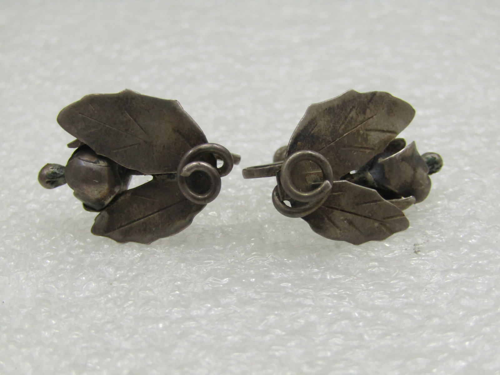 Vintage Sterling Leaf & Blossom Earrings, 1930's-1940's Screwback: Vintage Sterling Leaf & Blossom Earrings, 1930's-1940's Screwback. They are marked sterling and one earring seems to be signed but name cannot be determined. Tested and test as sterlnig at appx. 4.62