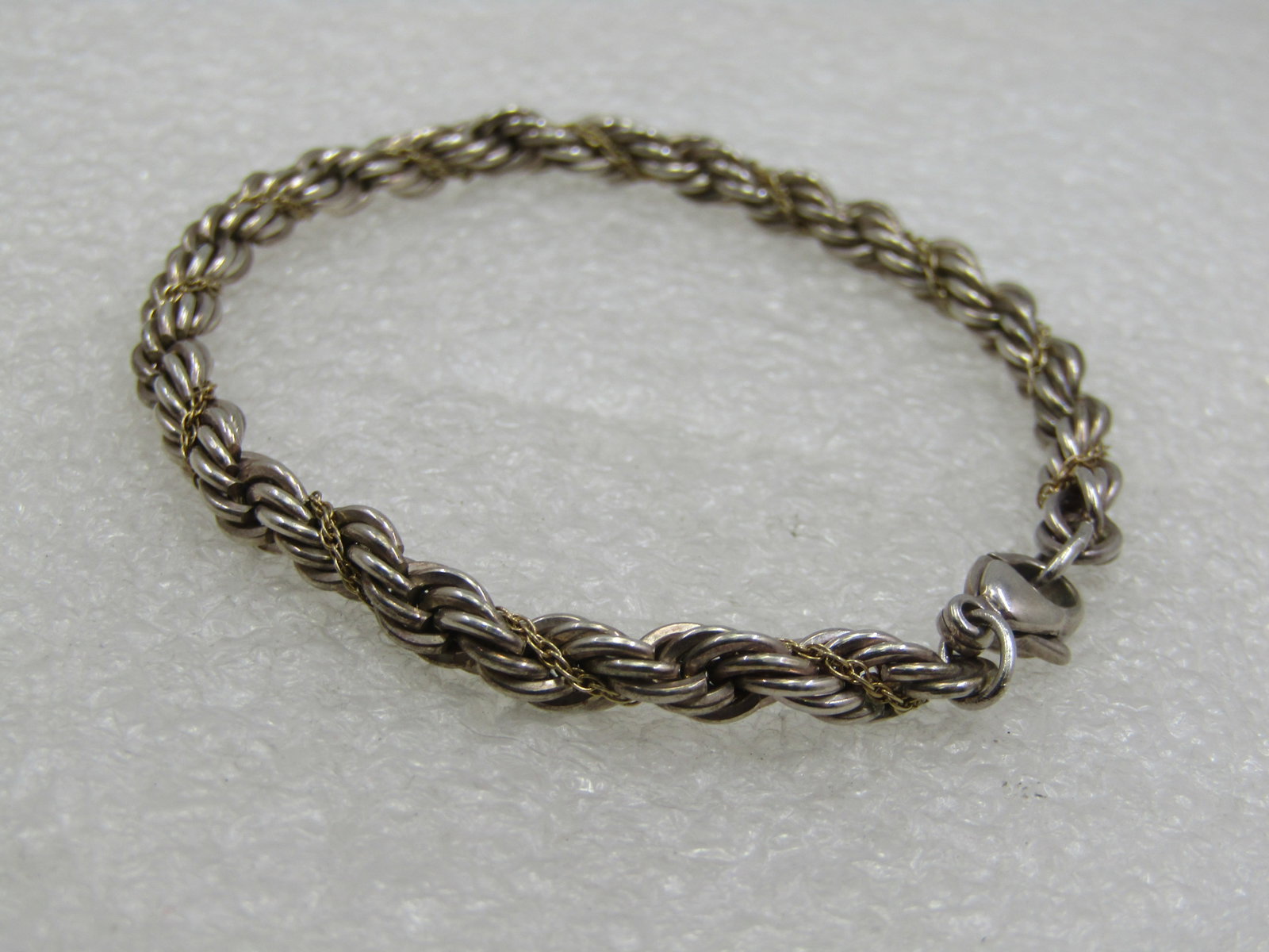 Vintage Sterling 4.5mm Twisted Rope Chain Bracelet, 7-1/8": Vintage Sterling 4.5mm Twisted Rope Chain Bracelet, 7-1/8". It is marked .925 and has a lobster clasp. Unisex. Not signed by the maker. Very good condition with light oxidation that can be polished