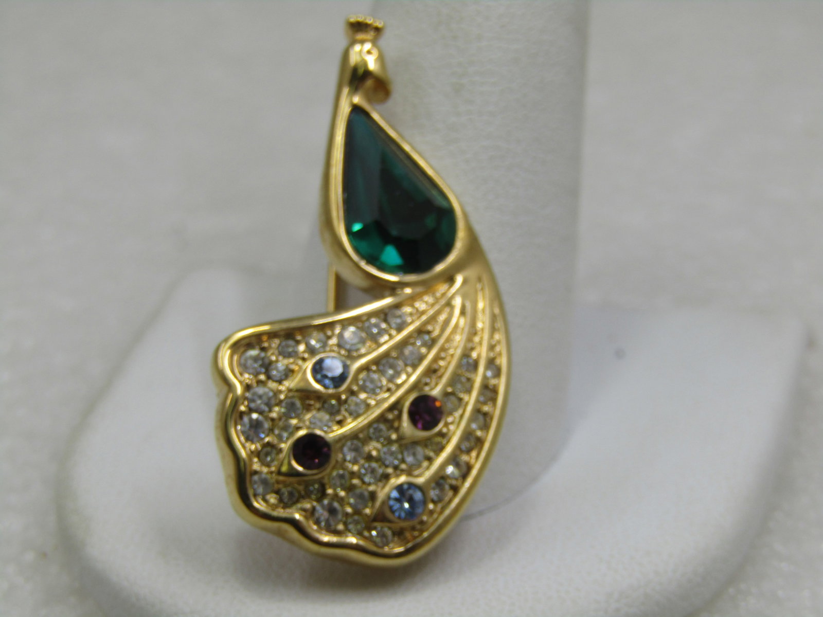 Vintage Rhinestone Peacock Brooch, 1.75", Gold Tone, 1970's-1980's: Vintage Rhinestone Peacock Brooch, 1.75", Gold Tone, 1970's-1980's, The pear-shaped emerald green rhinestones is appx. 12mm by 8mm and set in the torso. The tail has clear pave set rhinestones in