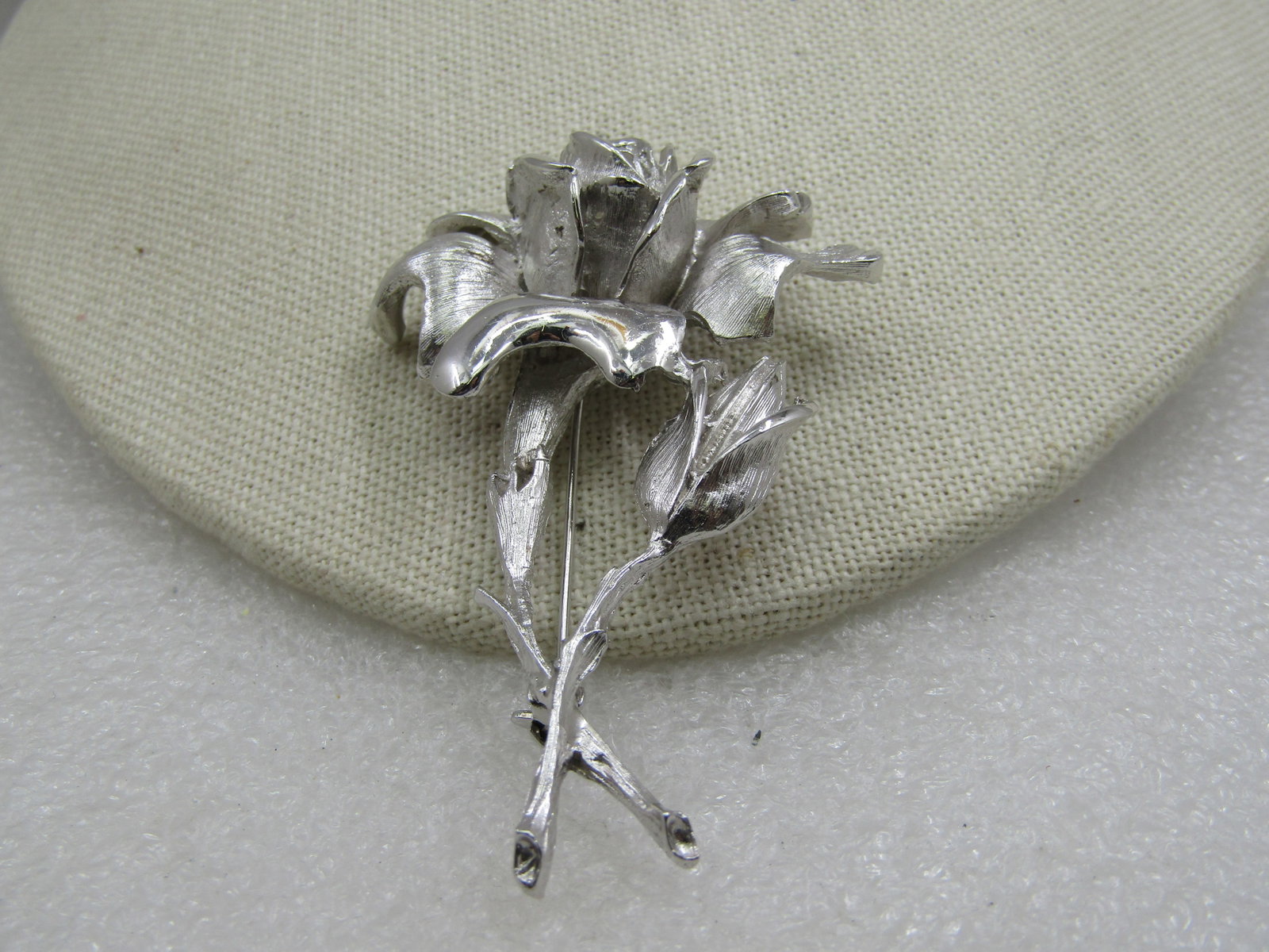 Vintage Silver Roses Brooch, 2.75" , 1960's-1970's.: Vintage Silver Roses Brooch, 2.75" tall and appx. 2" wide , 1960's-1970's. Open blossom rose in a textured and shiny finish with a bud on a stem. Very good condition. Not signed by the maker. Very