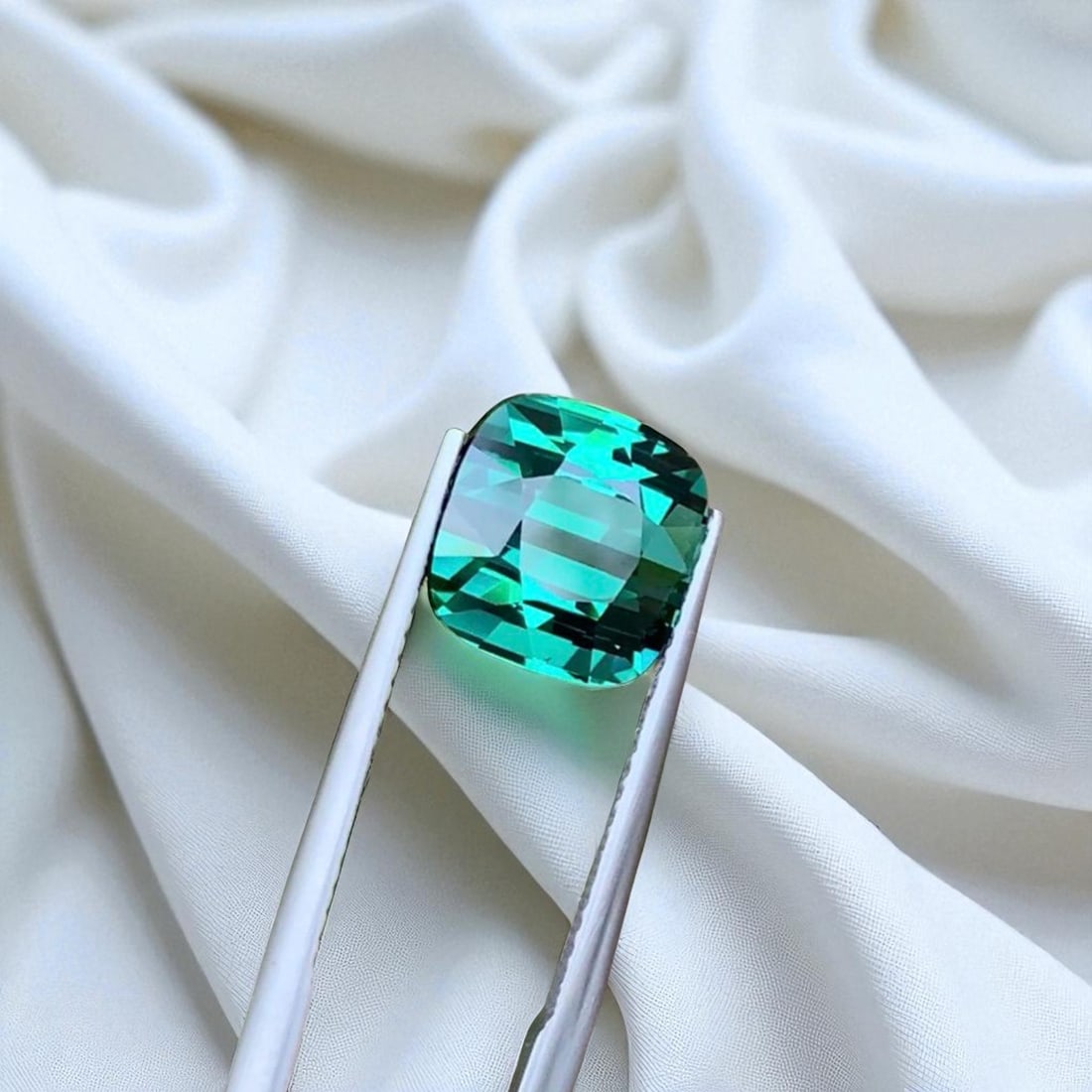 Bluish Tourmaline Gemstone For ring making, Natural Tourmaline Ring Stone: Title: Bluish Tourmaline Gemstone For ring making, Natural Tourmaline Ring Stone Description: Dimensions (mm) 9.5 x 9 x 7.9 mm Weight (cts) 5.65 Cushion Colours Description Bluish Tourmaline Gemstone 