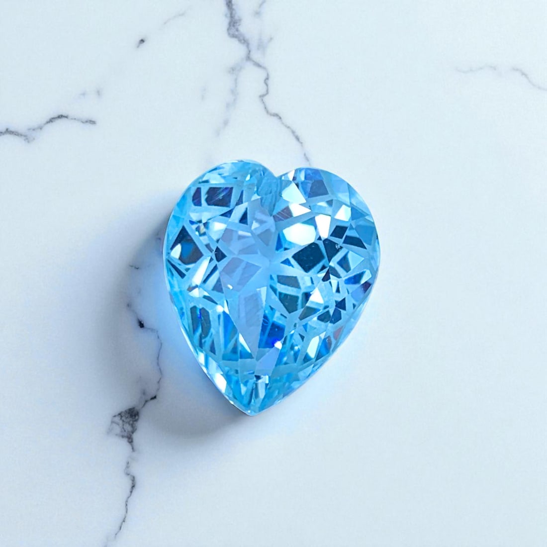 Swiss Blue Topaz Stone, Heart Shape Topaz Gemstone, Flower Cut Topaz: Title: Swiss Blue Topaz Stone, Heart Shape Topaz Gemstone, Flower Cut Topaz Description: Dimensions (mm) 17 x 14.7 x 10.5 mm Weight (cts) 18.7 Heart Colours Description Swiss Blue Topaz Stone, Heart