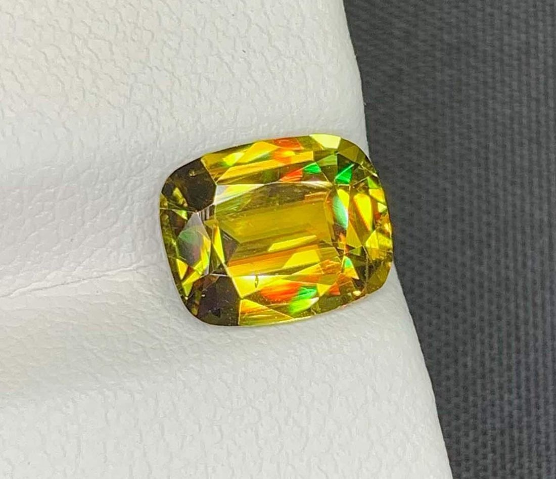 AIG Certified Lustrous Sphene Gemstone: Yellow/Green Cushion Cut, 2.76 Carat: Title: AIG Certified Lustrous Sphene Gemstone: Yellow/Green Cushion Cut, 2.76 Carat Description: Gemstone: Sphene Natural Sphene Titanite Gemstone, Full Fire Lustrous Yellow/Green Sphene Weight :