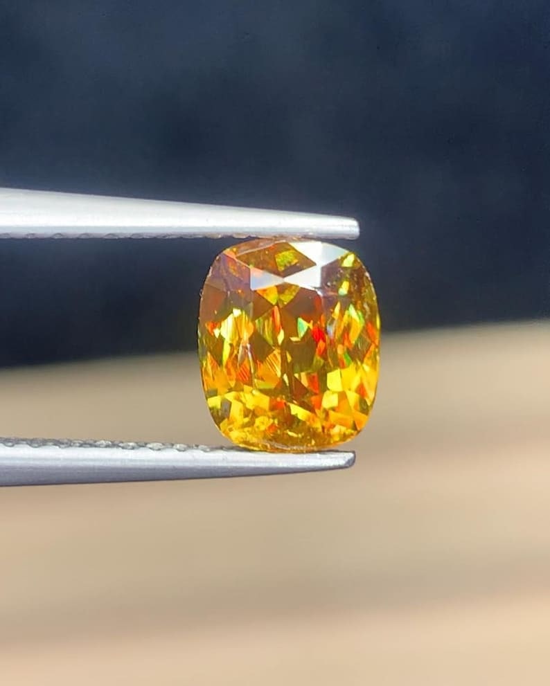 Ultra Fire Natural Titanite Sphene Cushion Cut Gemstone , March Birthstone - 1.60 Carat: Title: Ultra Fire Natural Titanite Sphene Cushion Cut Gemstone , March Birthstone - 1.60 Carat Description: Gemstone: Sphene Carat weight: 1.60 This stunning full fire sphene titanite loose gemstone f