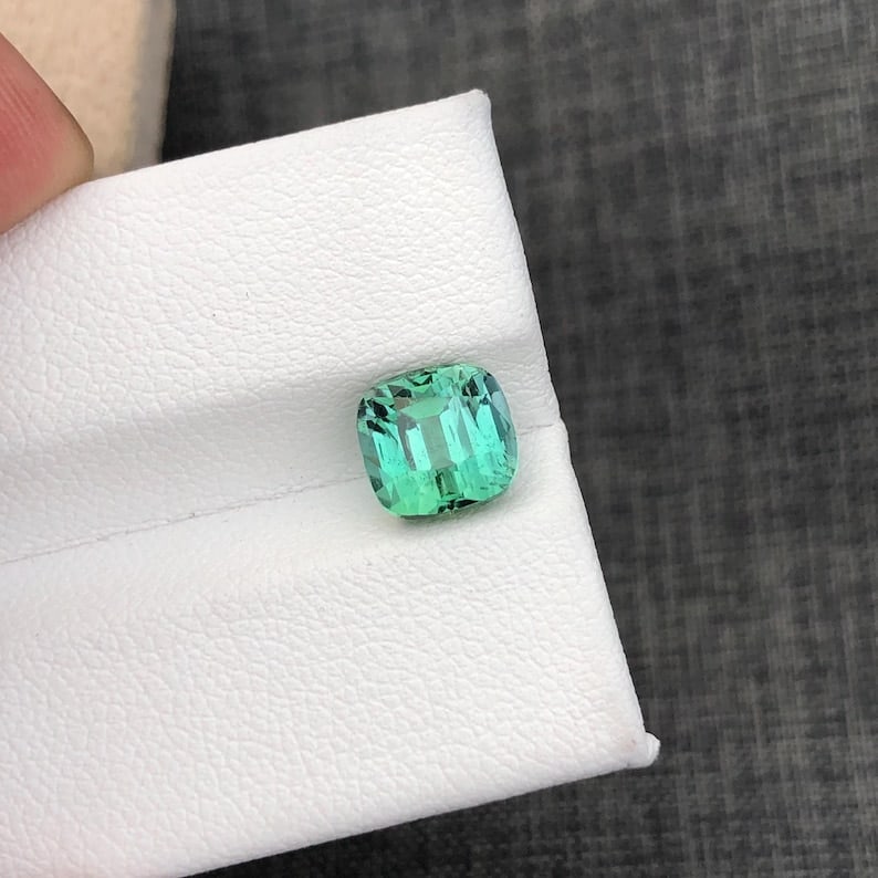 Mint Green Tourmaline Gemstone: 3.98 Carat Cushion Cut, Afghanistan: Title: Mint Green Tourmaline Gemstone: 3.98 Carat Cushion Cut, Afghanistan Description: Weight : 3.98 CT Dimensions : 8.5*7.9*7.5 MM Shape : Cushion Cut Clarity : Loupe Clean Color : Mint Green ( Jaba