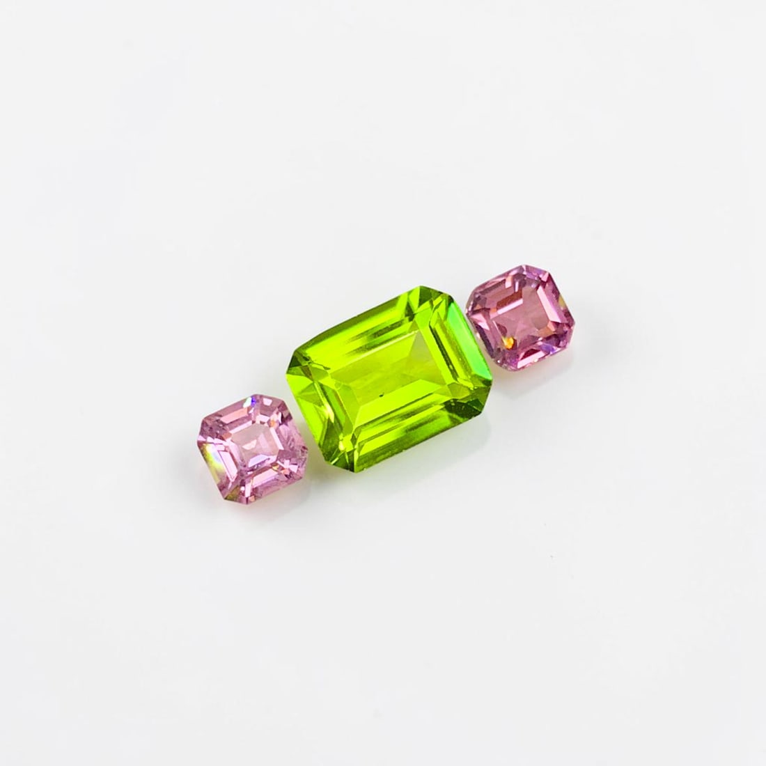 Olive Green Peridot Gemstone with Pink Spinel Stones For Ring: Title: Olive Green Peridot Gemstone with Pink Spinel Stones For Ring Description: Dimensions (mm) 9 x 7 x 4 mm Weight (cts) 3.35 Emerald, Asscher Colours Description Olive Green Peridot Gemstone with