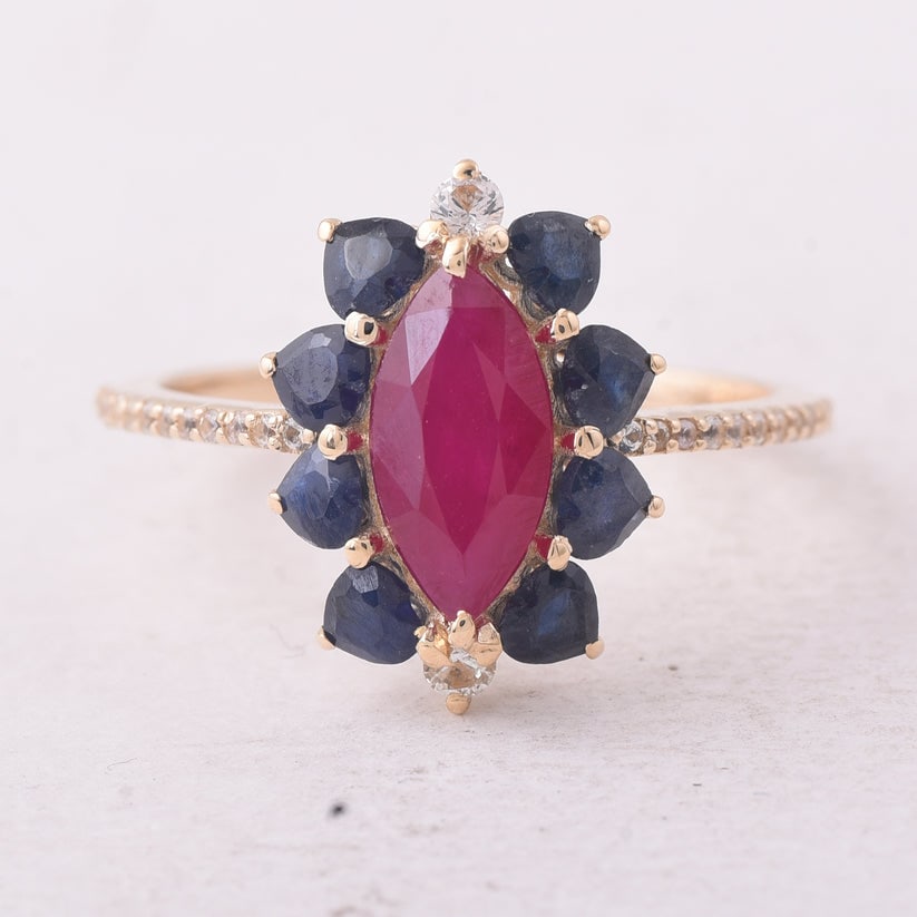 2.56 Ct Marquise Ruby 9K Gold Ring: 2.56 Total Carat Ruby 9K Gold Ring Specifications: Total Weight 2.155 g Center Gemstone Ruby Gemstone Carat Weight 1.3 Carats Gemstone Measurements 10.10X5.10X3.10 mm Additional Gemstones Blue Sapphir
