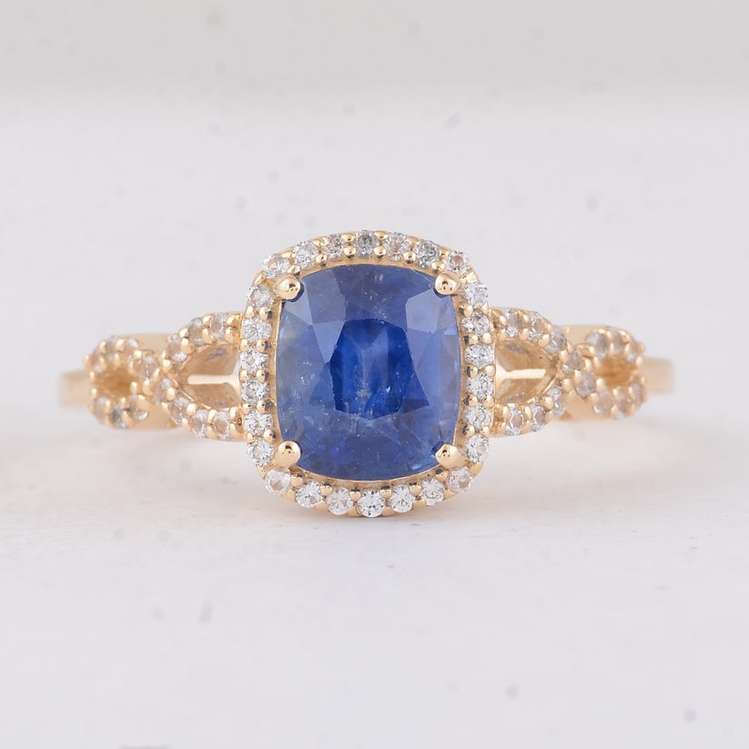 2.13 Ct Cushion Sapphire 9K Gold Ring: 2.13 Total Carat Sapphire 9K Gold Ring Specifications: Total Weight 2.21 g Center Gemstone Sapphire Gemstone Carat Weight 1.89 Carats Gemstone Measurements 7X6X4.80 mm Additional Gemstones White