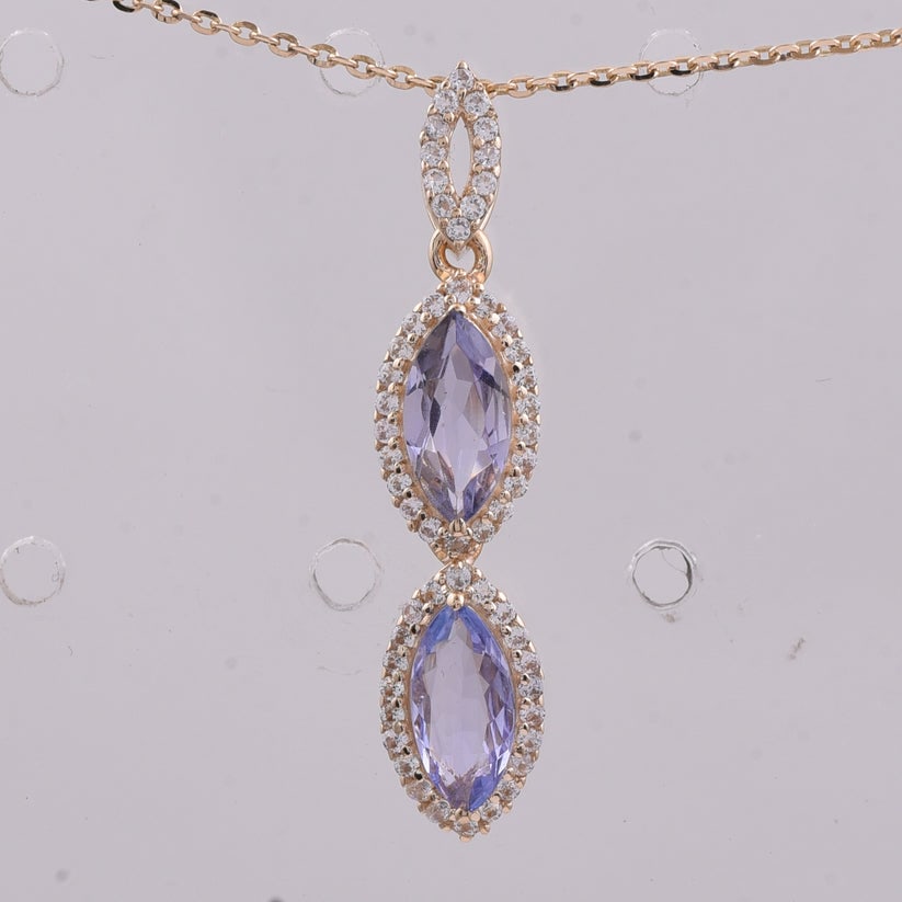 1.00 Ct Marquise Tanzanite 9K Gold Pendant: 1.00 Total Carat Tanzanite 9K Gold Pendant Specifications: Total Weight 0.997 g Center Gemstone Tanzanite Gemstone Carat Weight 0.78 Carats Gemstone Measurements 8X4 mm Additional Gemstones White