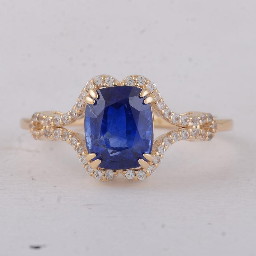 2.51 Ct Cushion Sapphire 9K Gold Ring: 2.51 Total Carat Sapphire 9K Gold Ring Specifications: Total Weight 2.2 g Center Gemstone Sapphire Gemstone Carat Weight 2.31 Carats Gemstone Measurements 7.80X6.40X4.20 mm Additional Gemstones White 